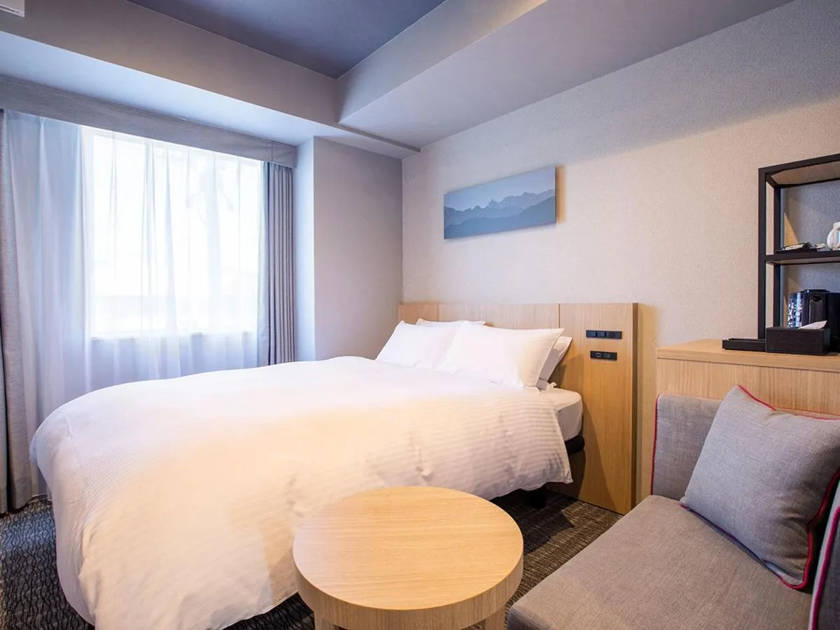 Bed in KOKO HOTEL Hidatakayama - formaly Hotel Wing Hida Takayama