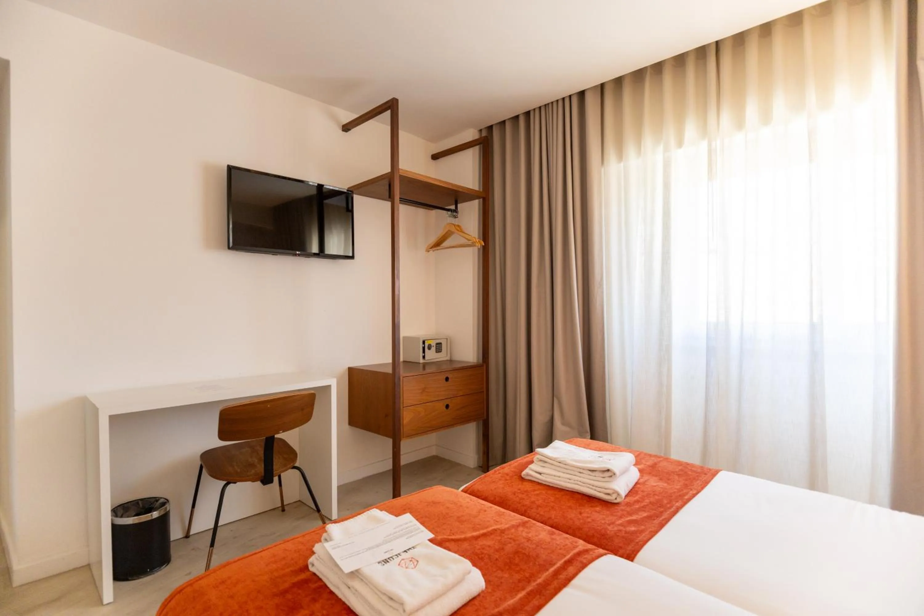 Bed in The ICONS Lisbon Hotel