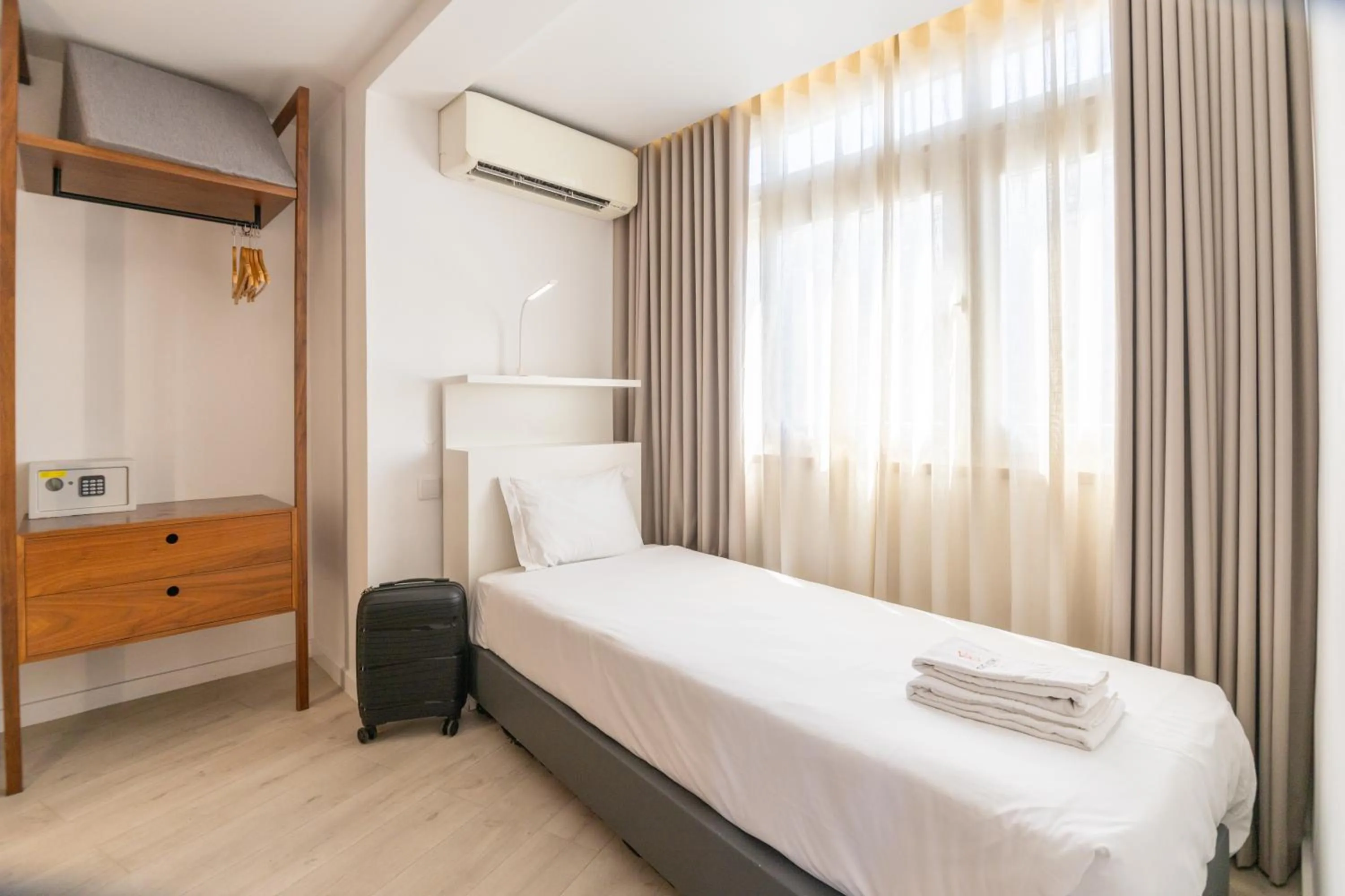 Bed in The ICONS Lisbon Hotel