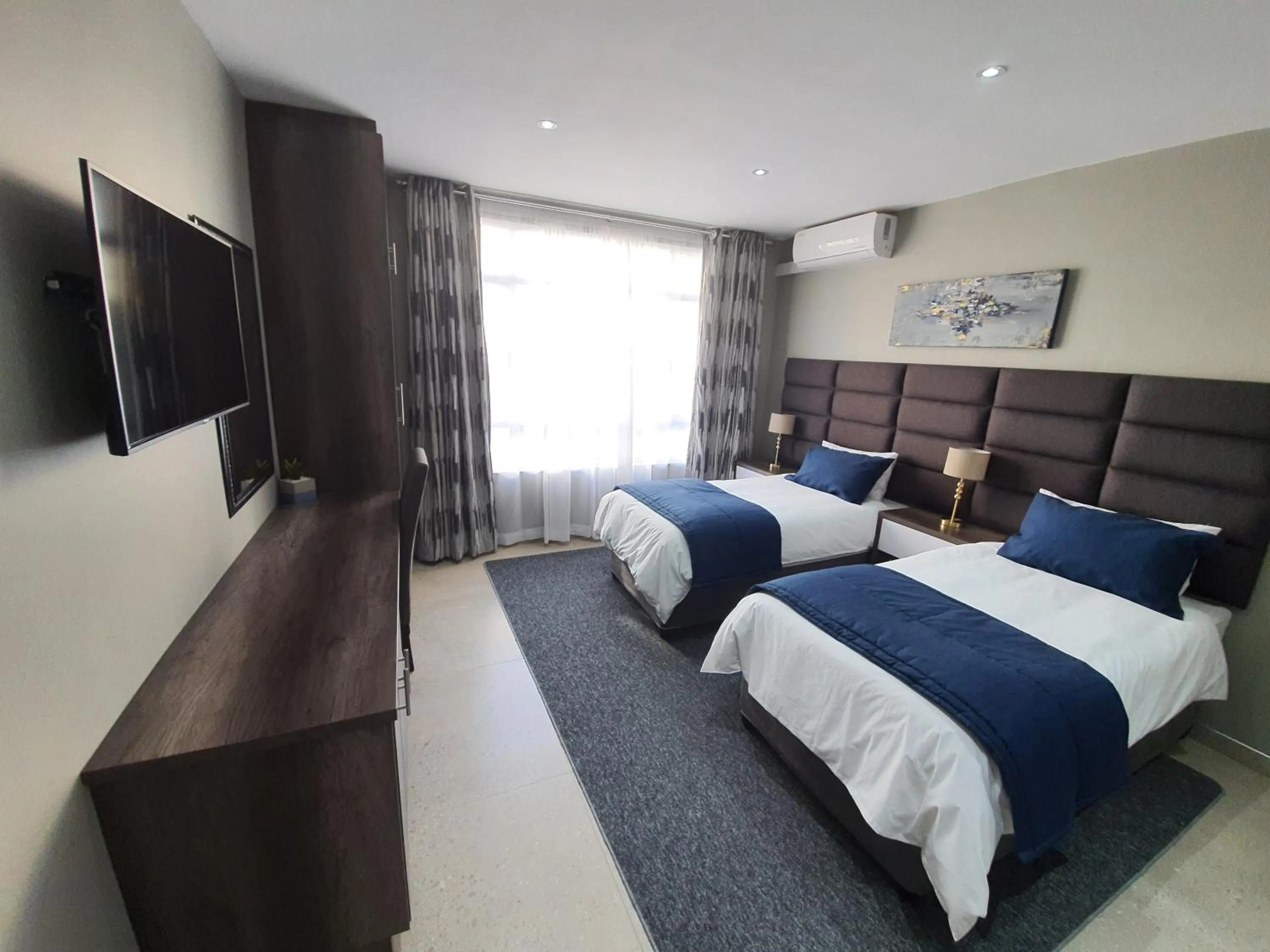 Bed in The Cato Suites Hotel