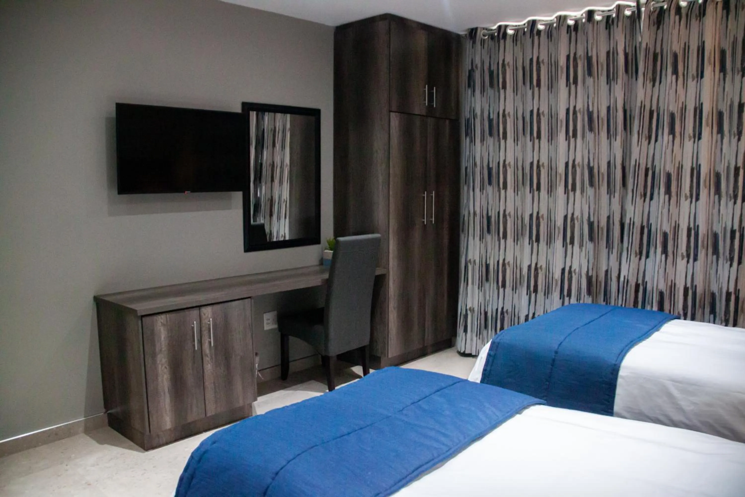 Bed in The Cato Suites Hotel