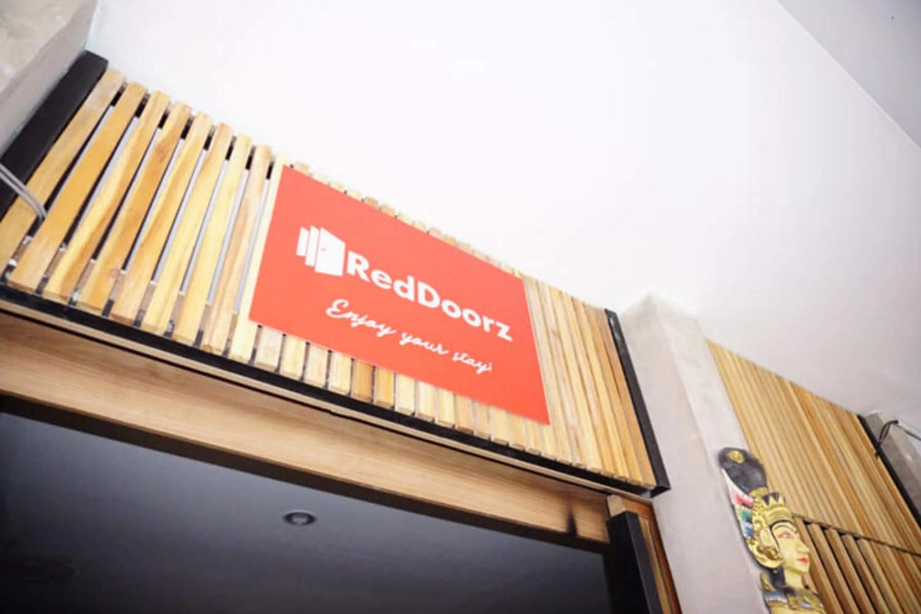 Property logo or sign in RedDoorz Hostel Near Ngurah Rai Airport Kuta