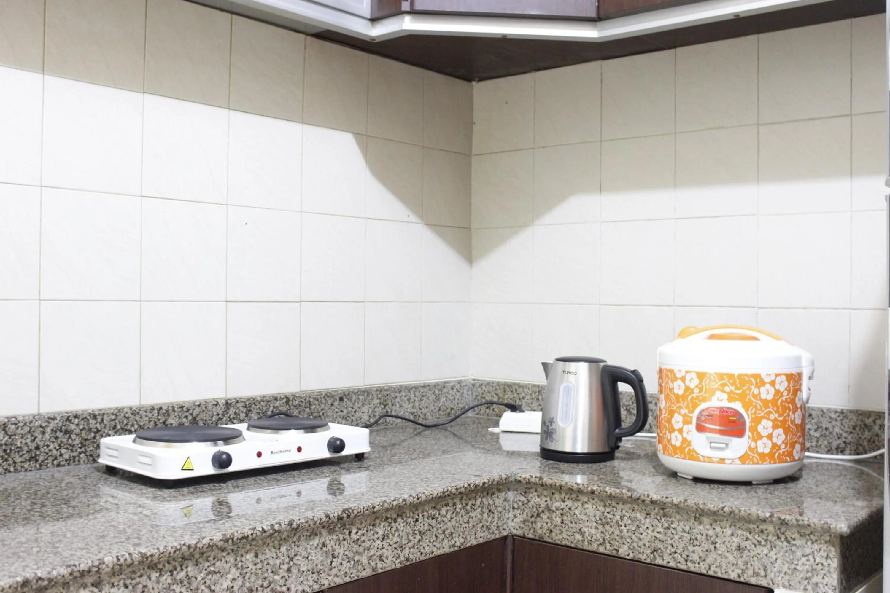 Kitchen or kitchenette in Deluxe & Cozy 4BR Galeri Ciumbuleuit Apartment By Travelio