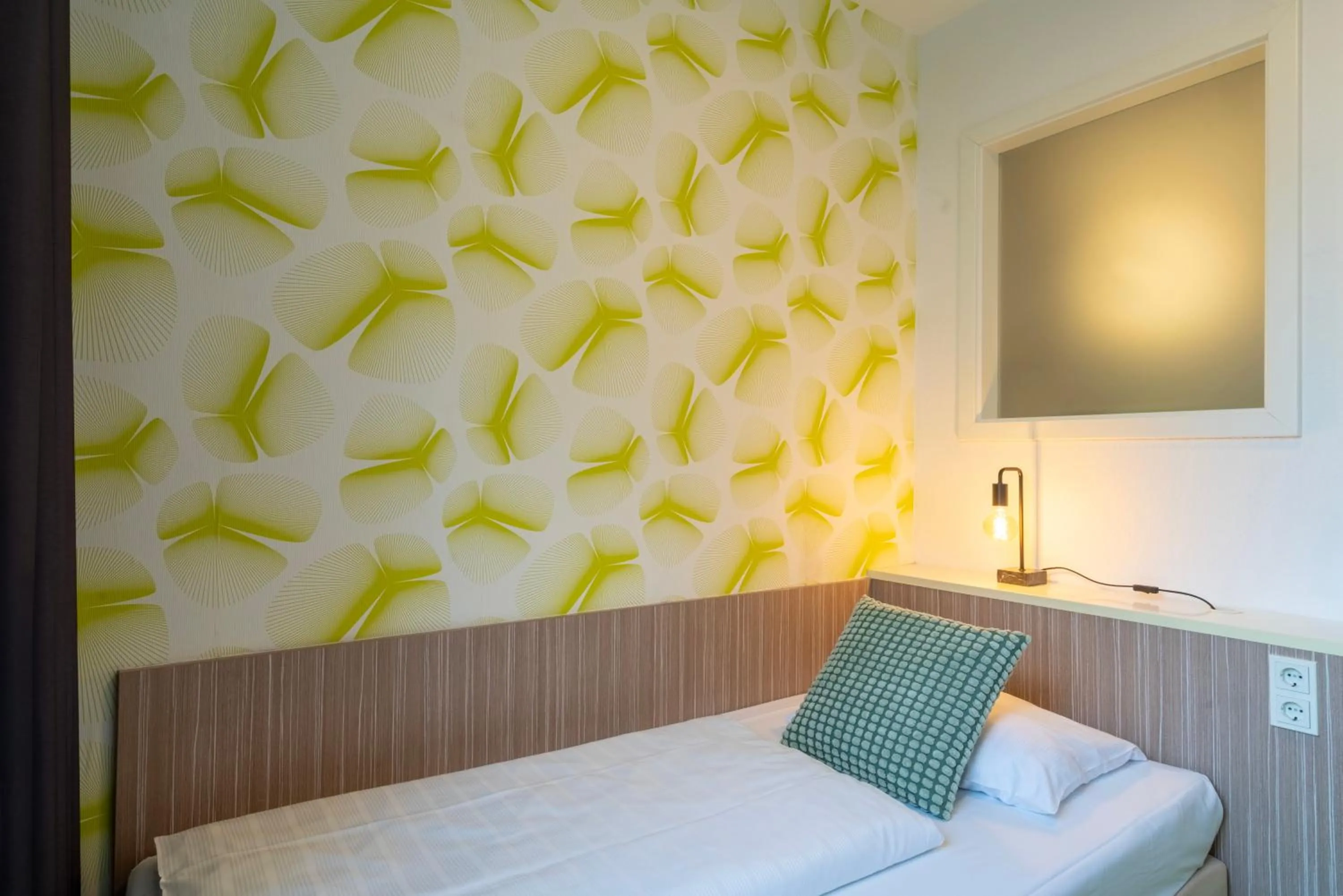 Bed in Hotel Madeleine Biohotel