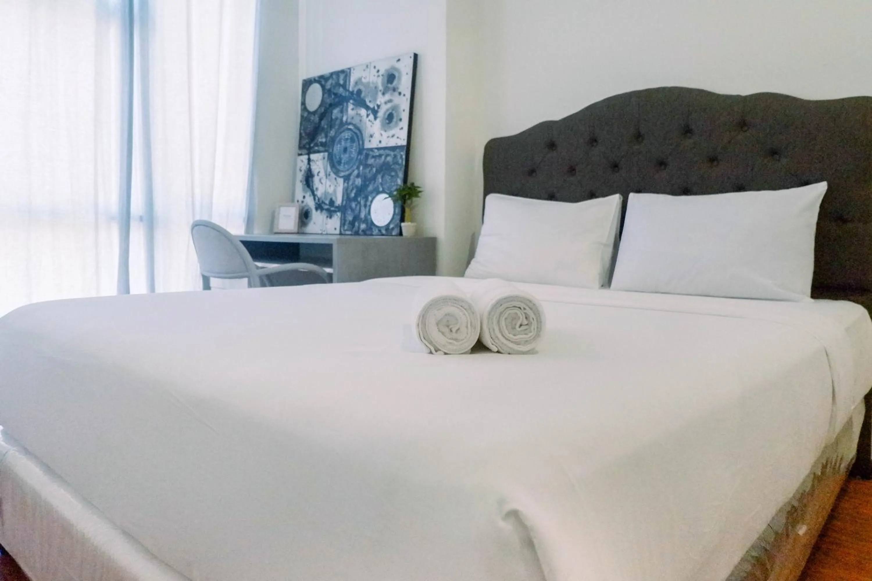 Bed in Lavish 2BR Apartment at Grand Sungkono Lagoon By Travelio