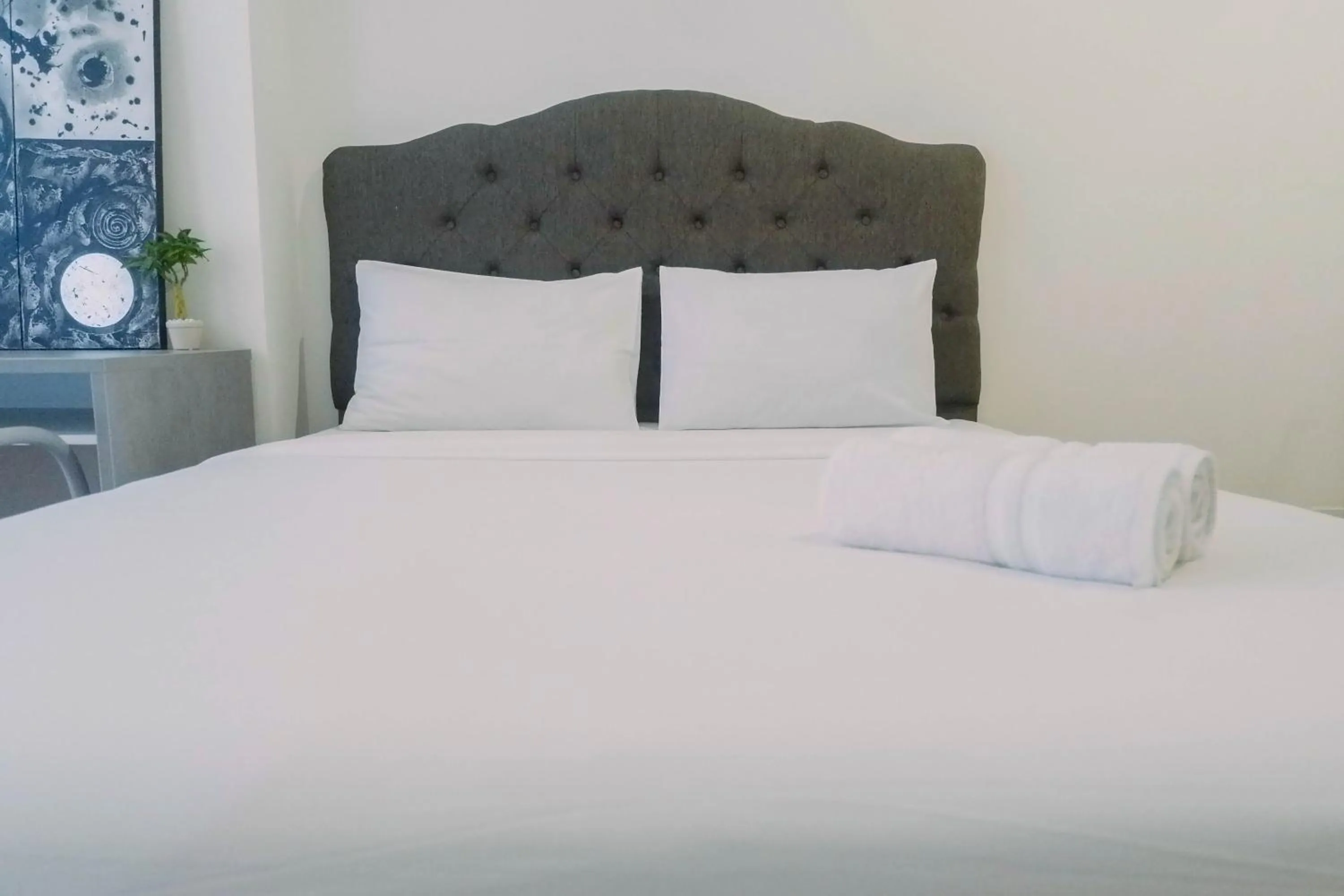 Bed in Lavish 2BR Apartment at Grand Sungkono Lagoon By Travelio