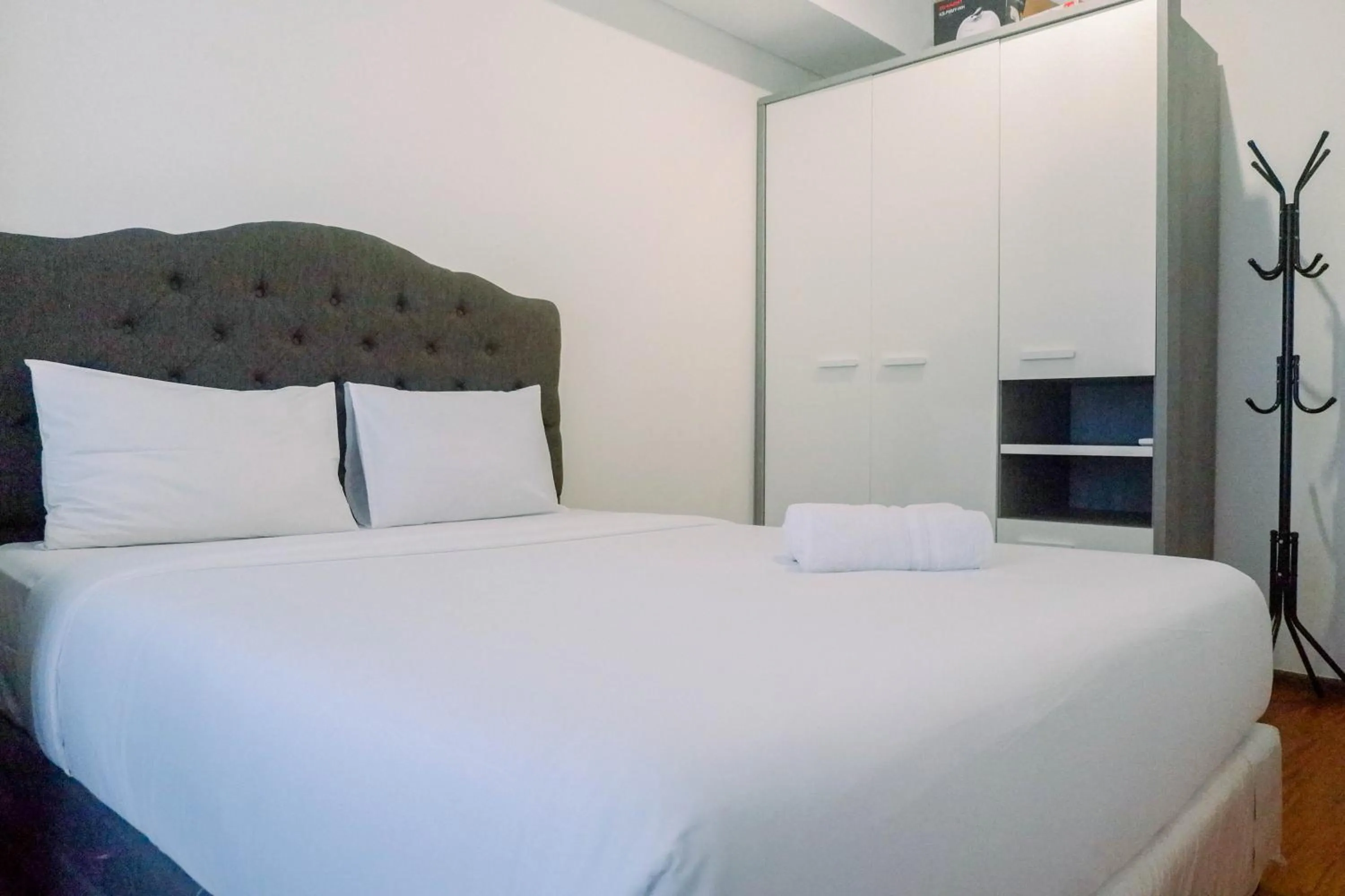 Bed in Lavish 2BR Apartment at Grand Sungkono Lagoon By Travelio