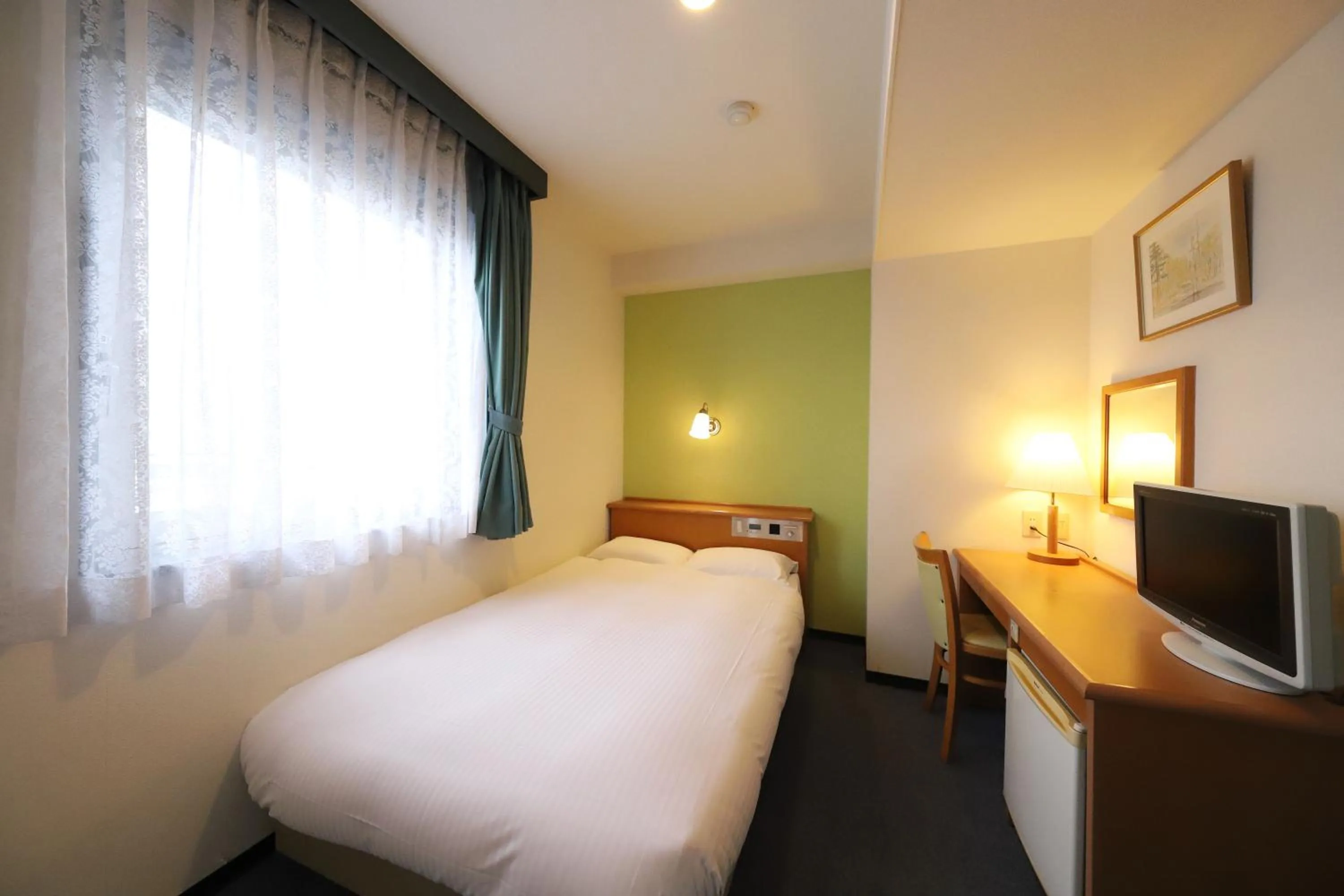 Bed in Smile Hotel Takaoka Ekimae