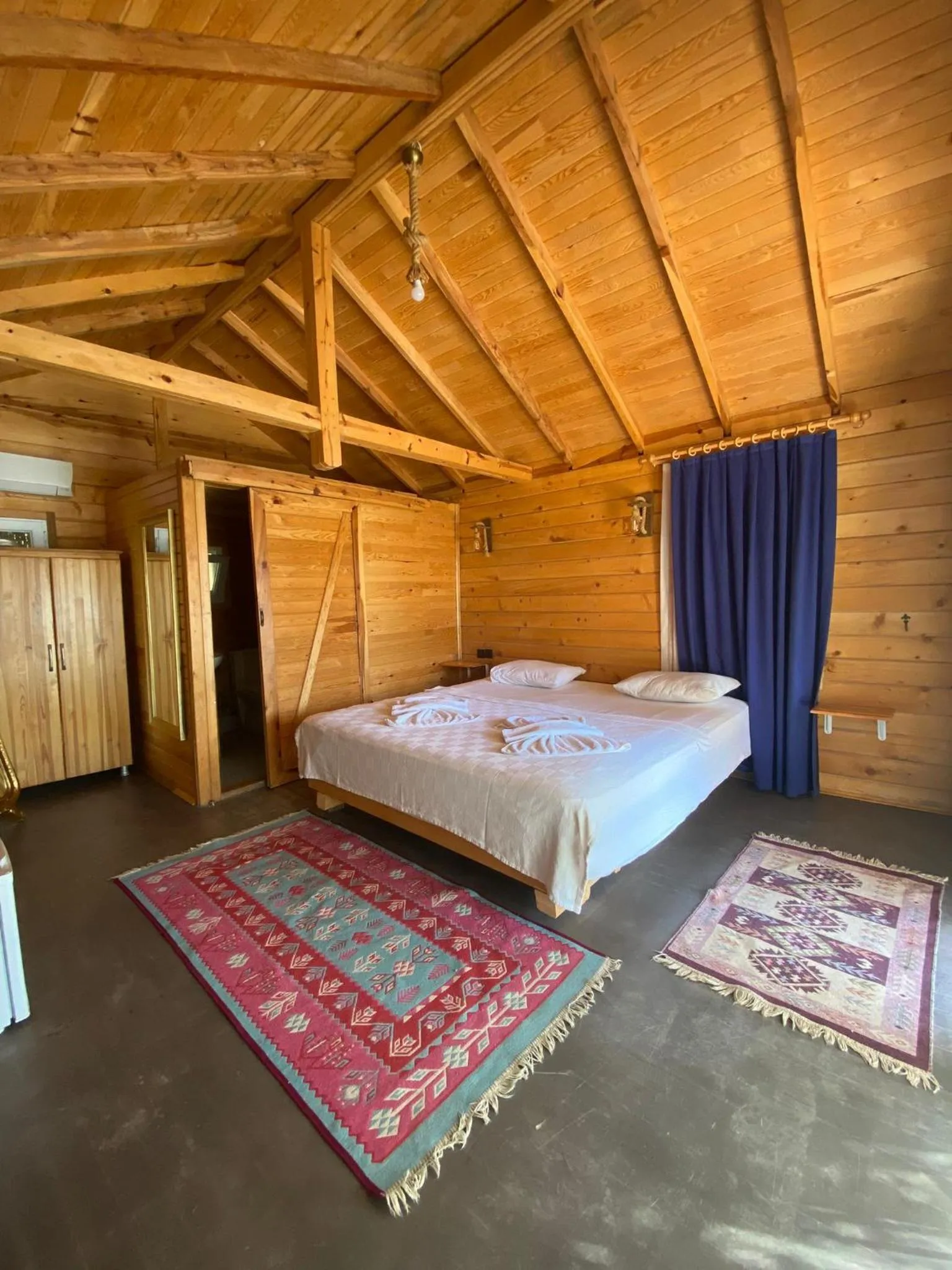 Bed in Green Pine Bungalows & Beach Luxury Concept