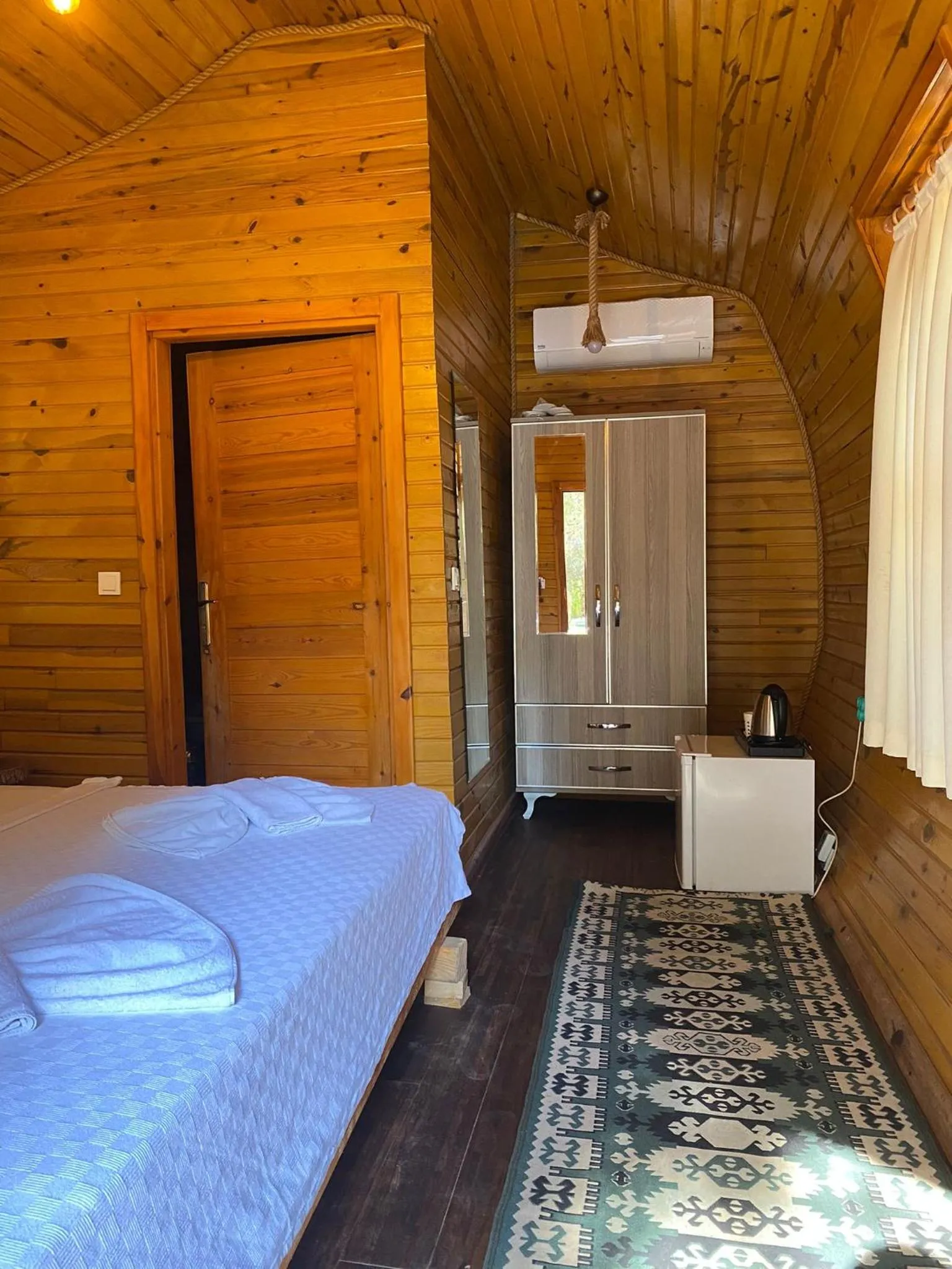 Bed in Green Pine Bungalows & Beach Luxury Concept