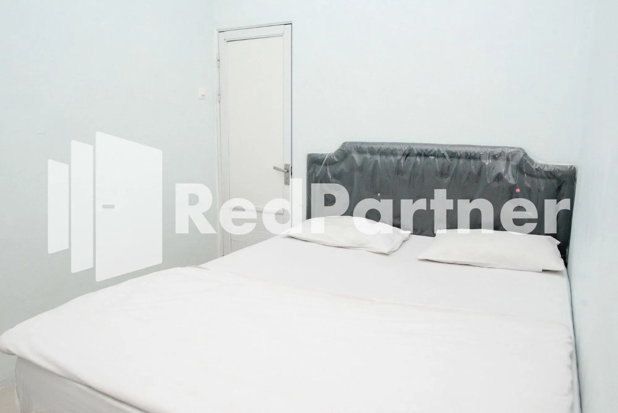 Bed in Happy Inn Puspo Mitra RedDoorz