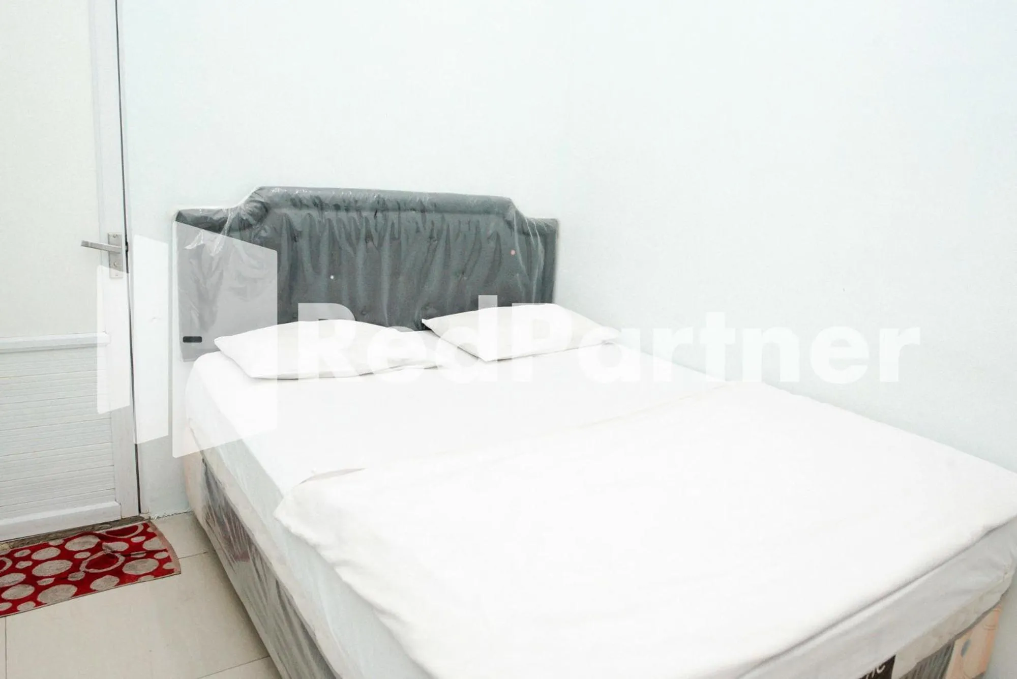 Bed in Happy Inn Puspo Mitra RedDoorz