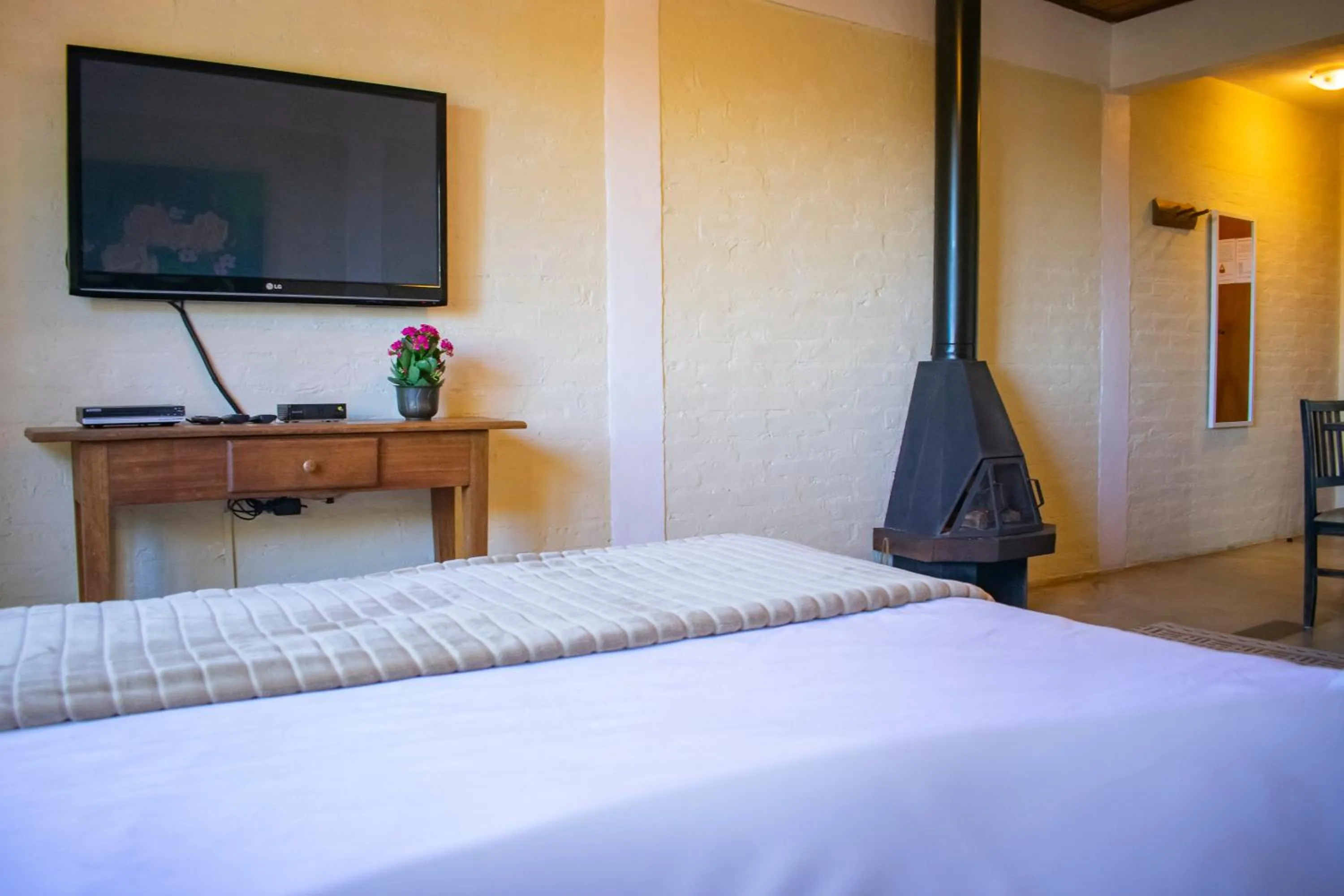 fireplace, Bed in Pousada VillaSerrana