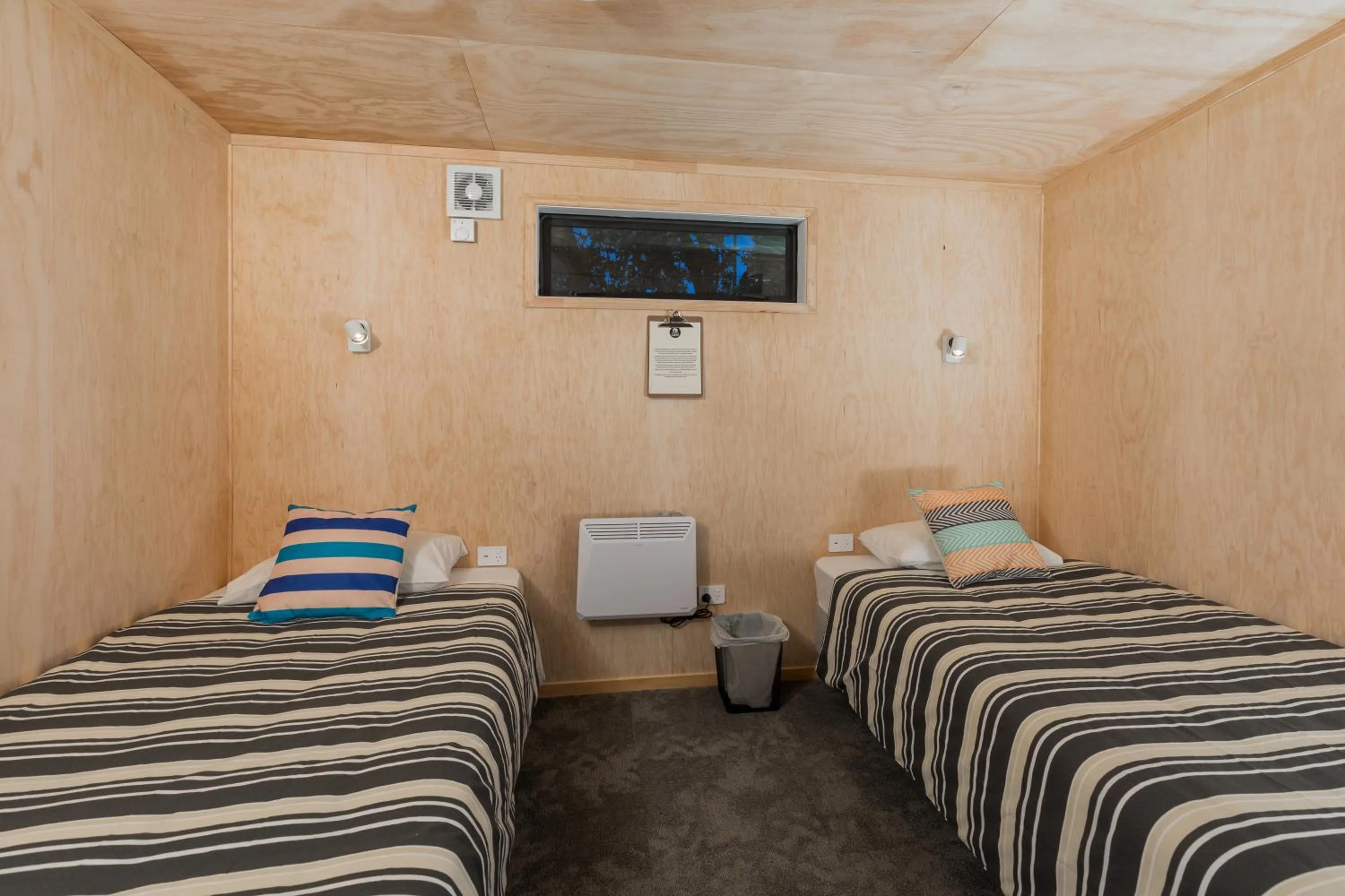 Bed in Waitomo Homestead Cabins