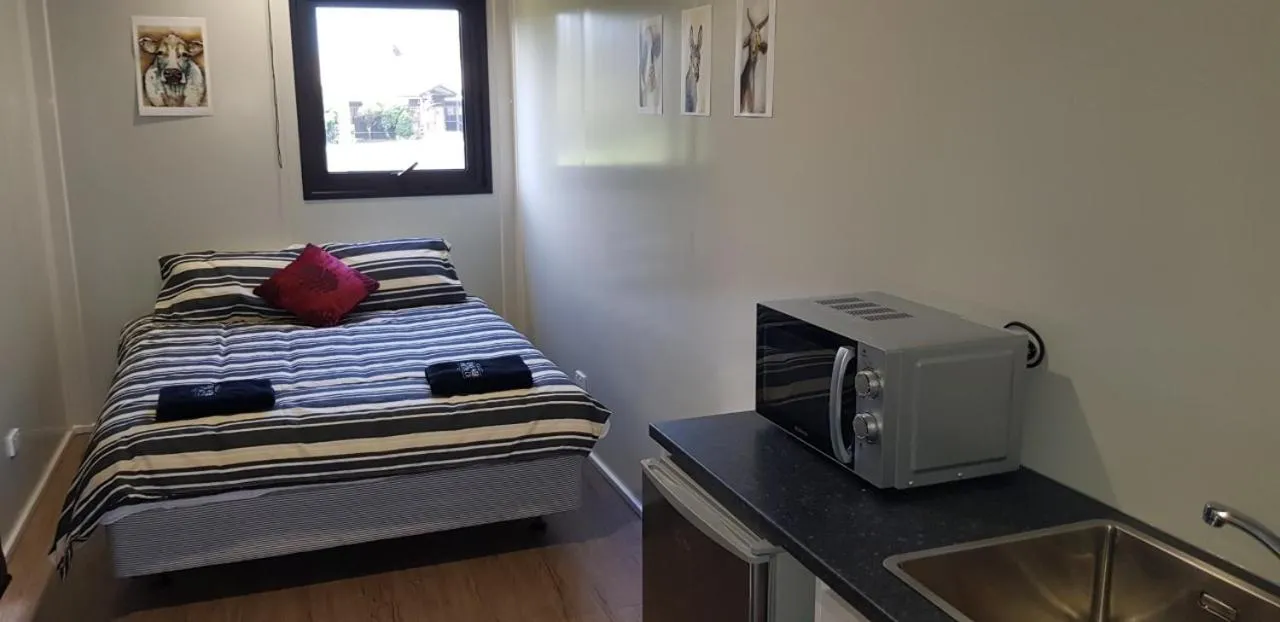 Bed in Waitomo Homestead Cabins