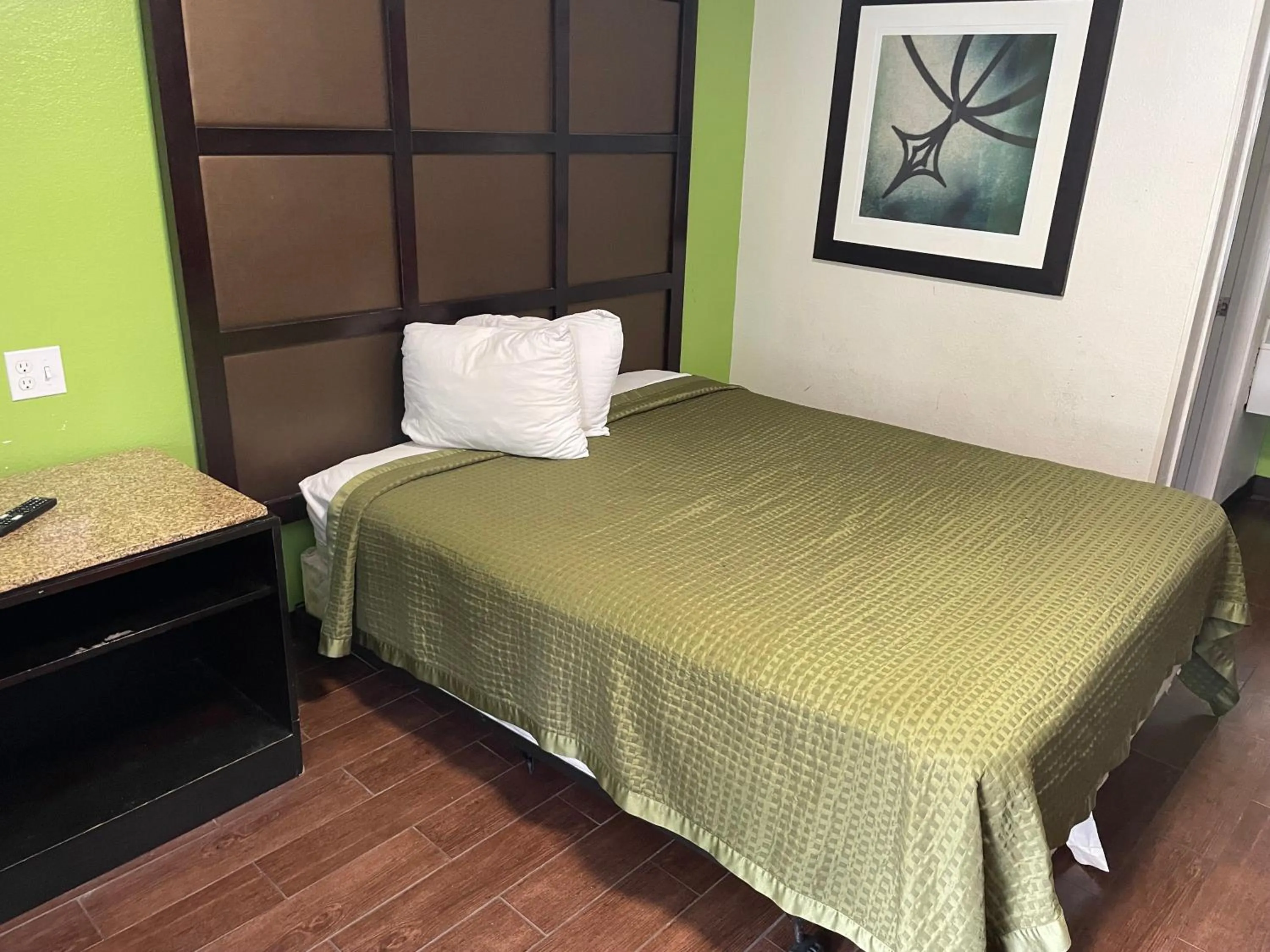 Bed in Sunrise Extended Stay Hotel