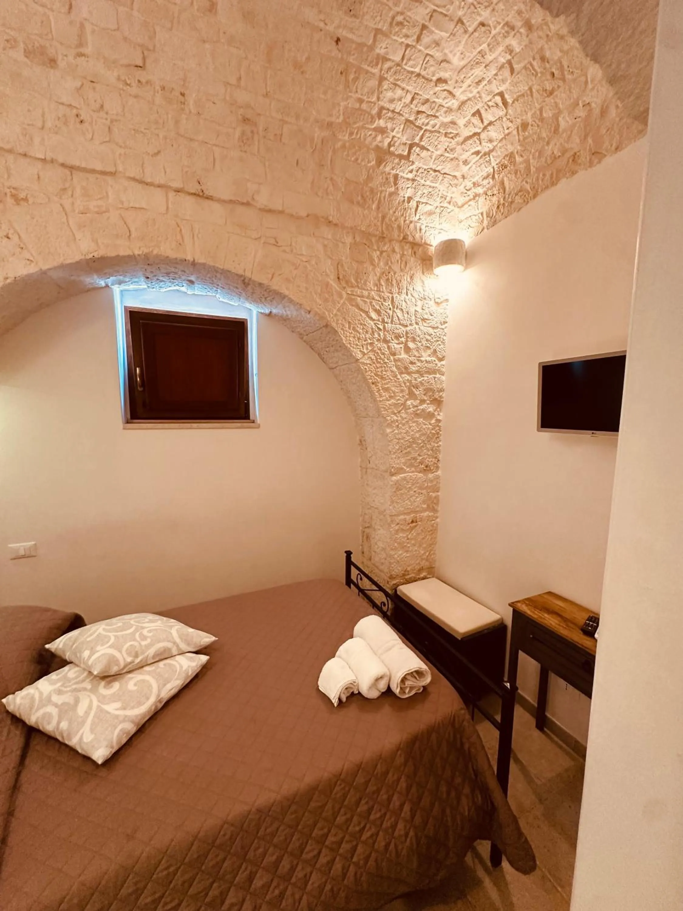 Bed in Pietra Rosa Apulian Home