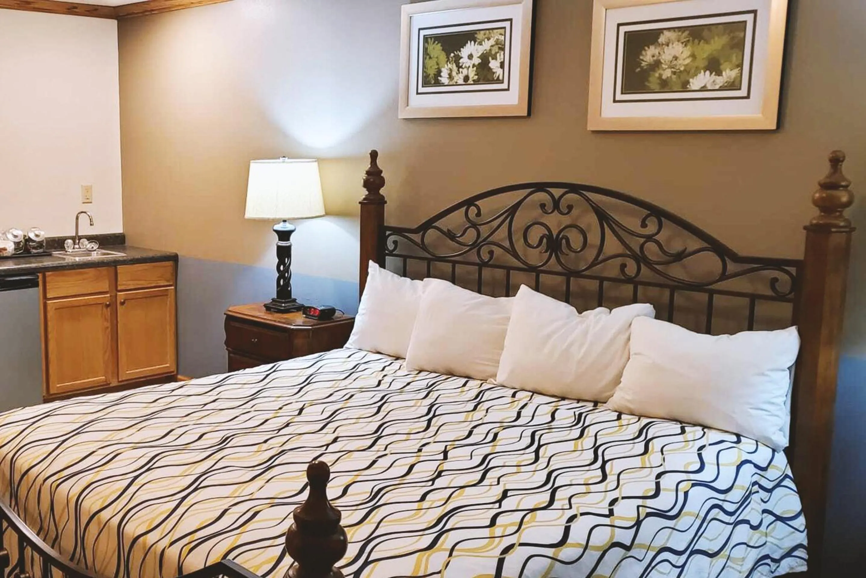 Bed in Coratel Inn & Suites by Jasper McCook