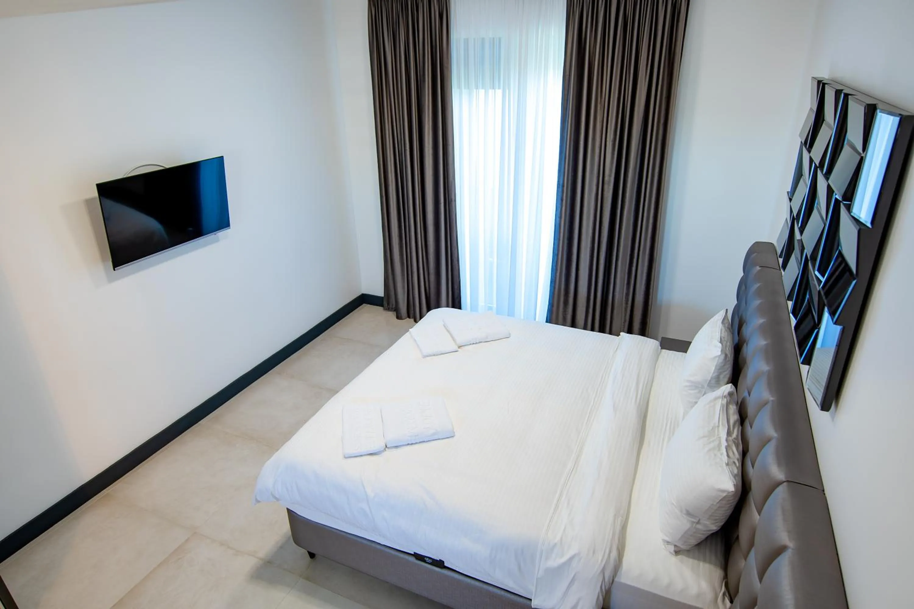 Bed in Enjoy Life Apartments