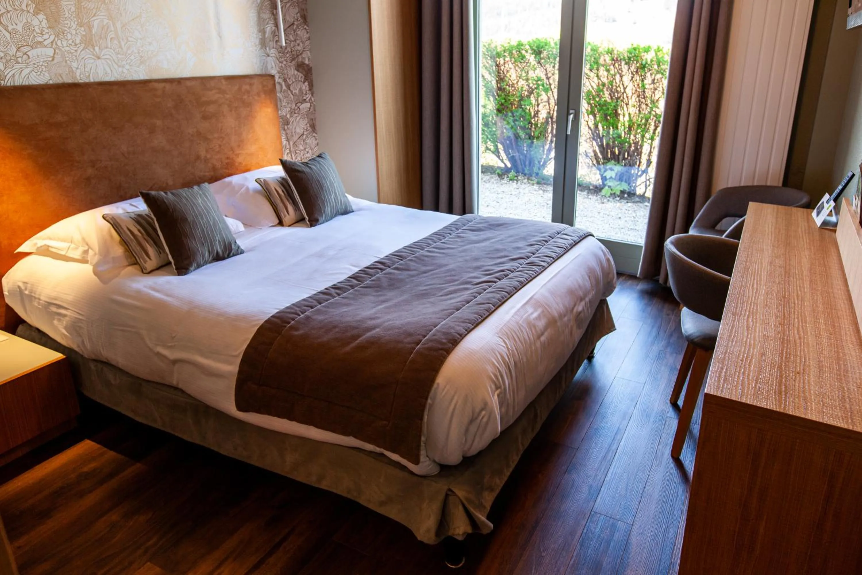 Bed in Logis Hotel Restaurant La Tour