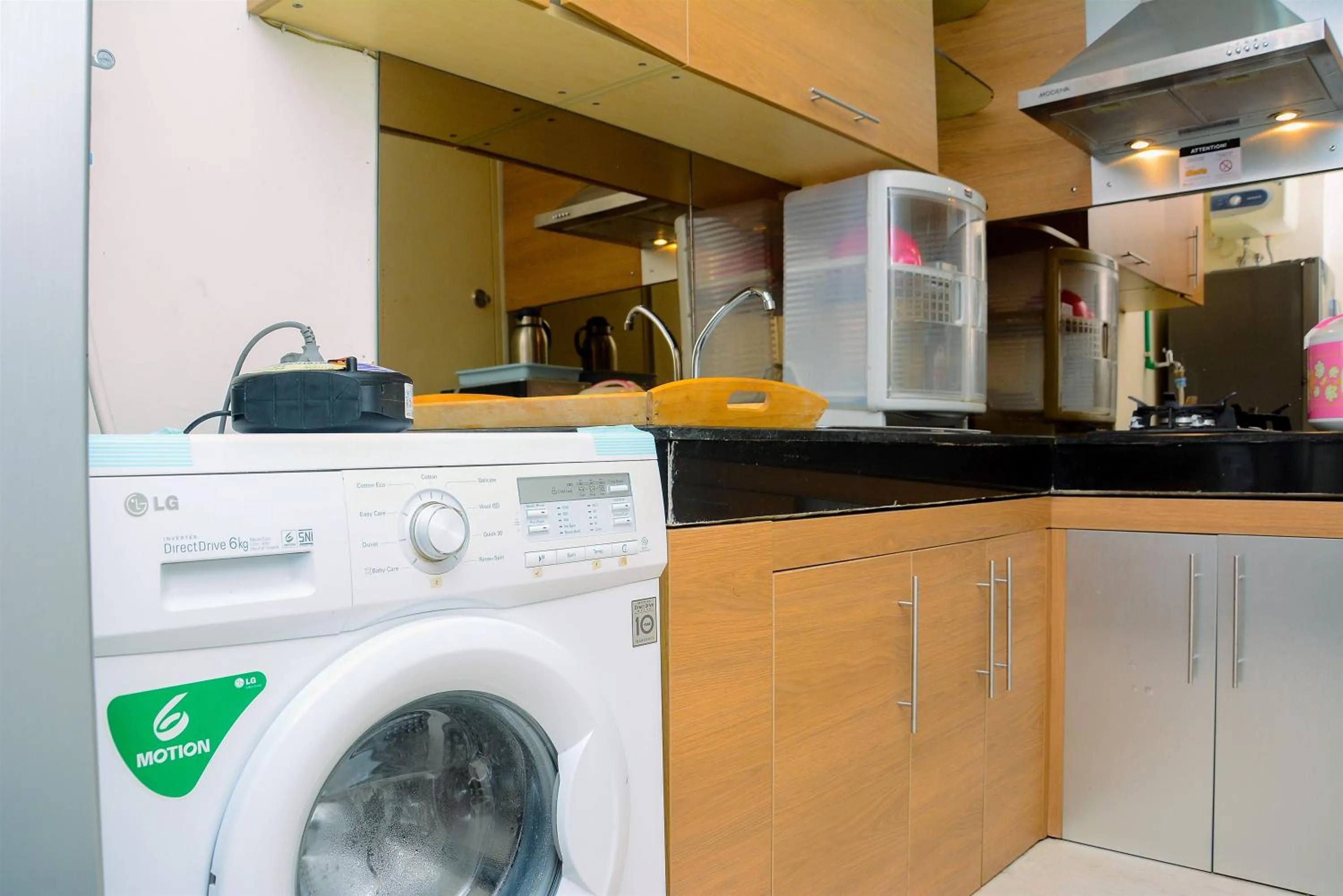 Kitchen or kitchenette in Modern and Luxurious 2BR Essence Dharmawangsa Apartment By Travelio