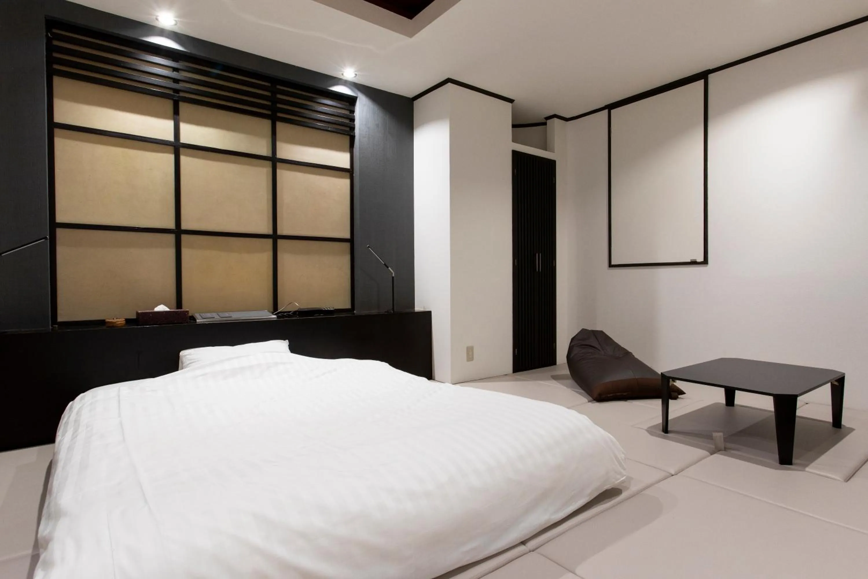 Bed in THE MANGA HOTEL TOGO