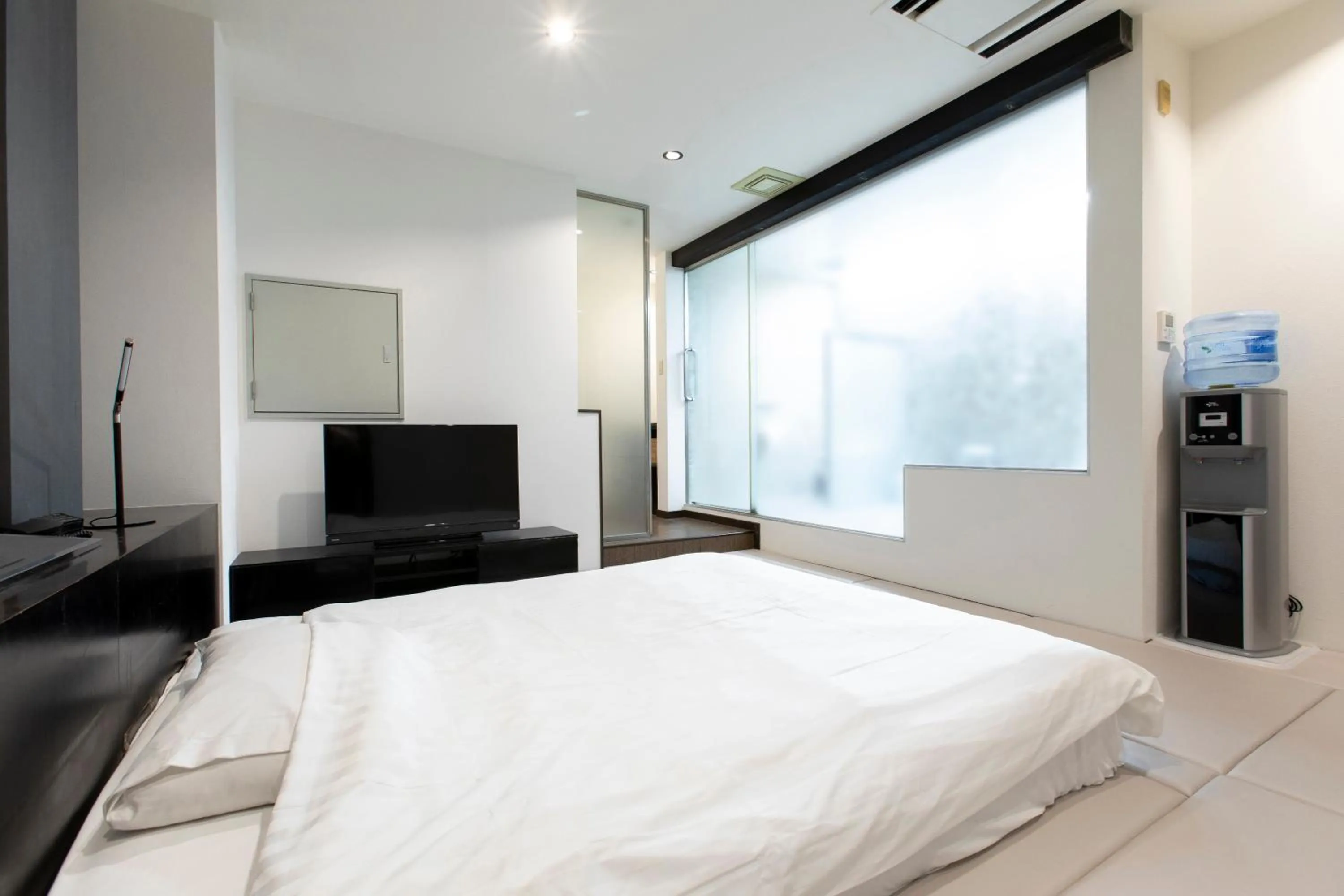 Bed in THE MANGA HOTEL TOGO