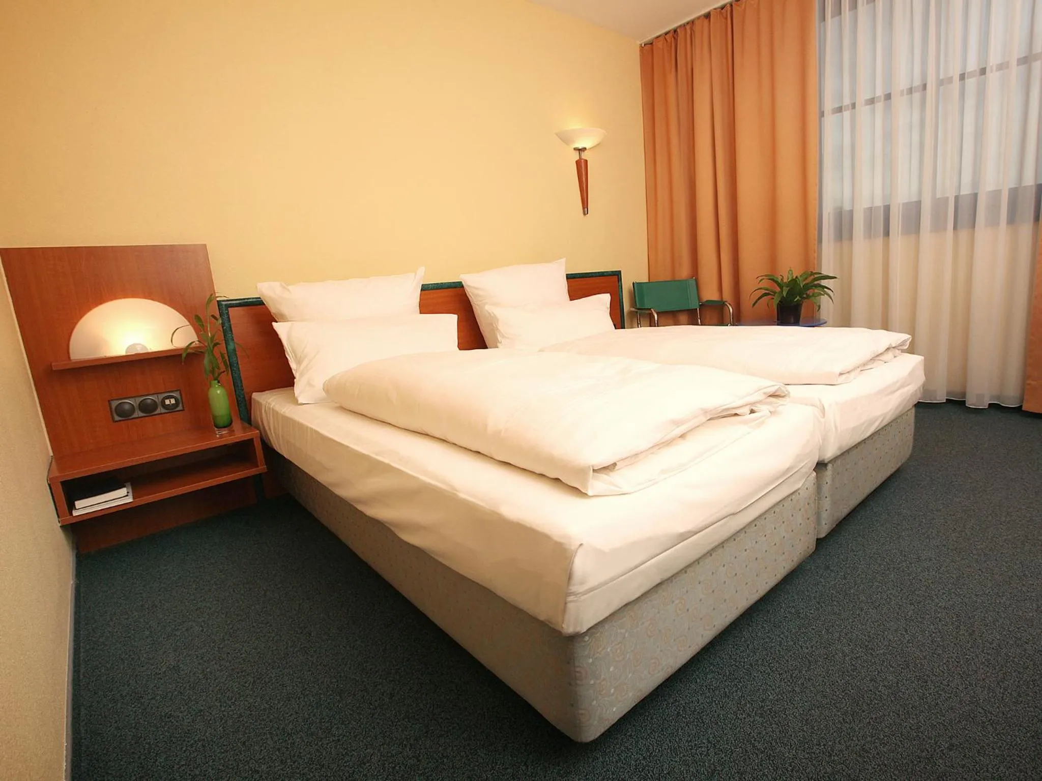 Bed in Transmar Travel Hotel