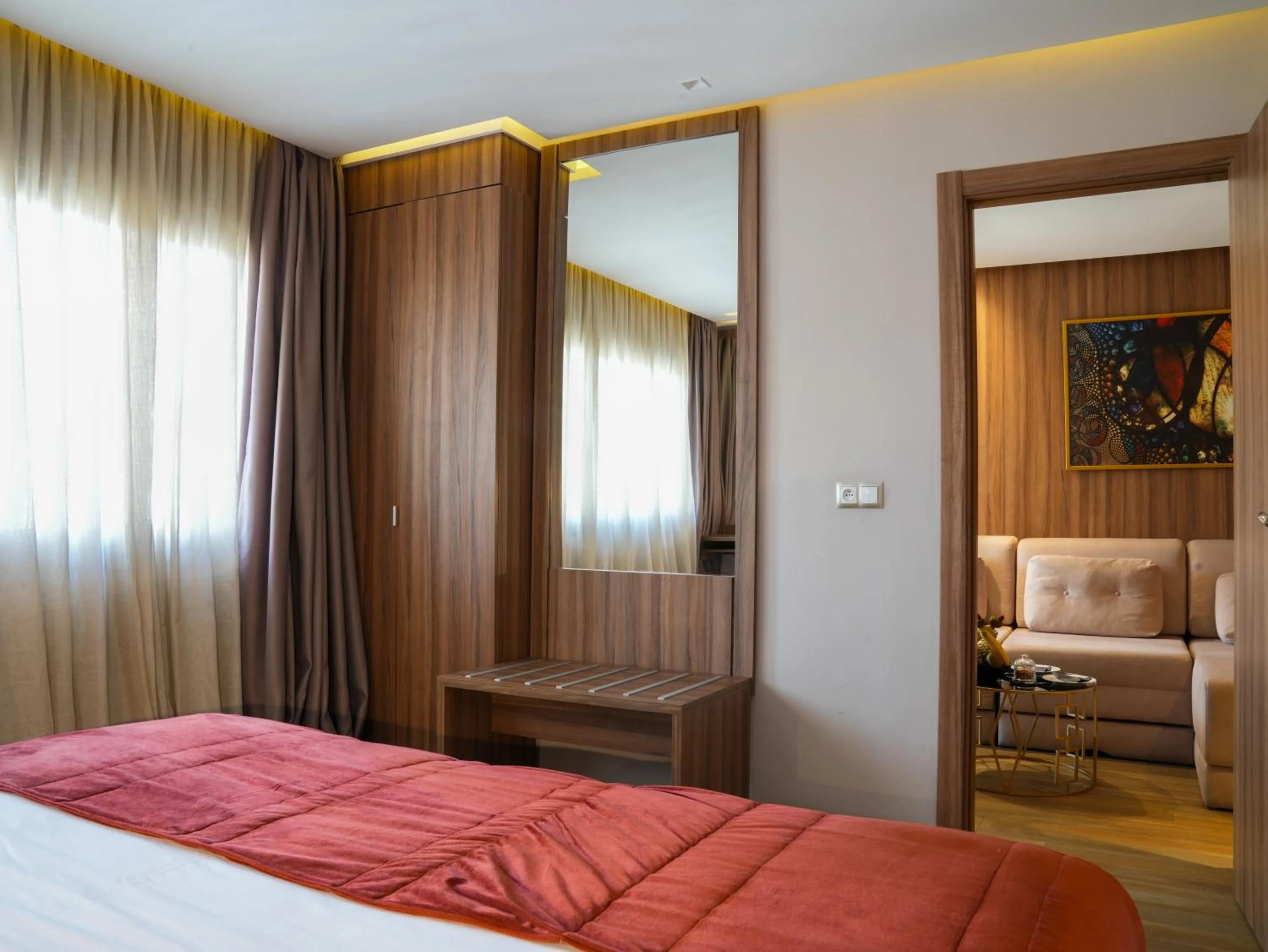 Living room, Bed in First Suites Hôtel