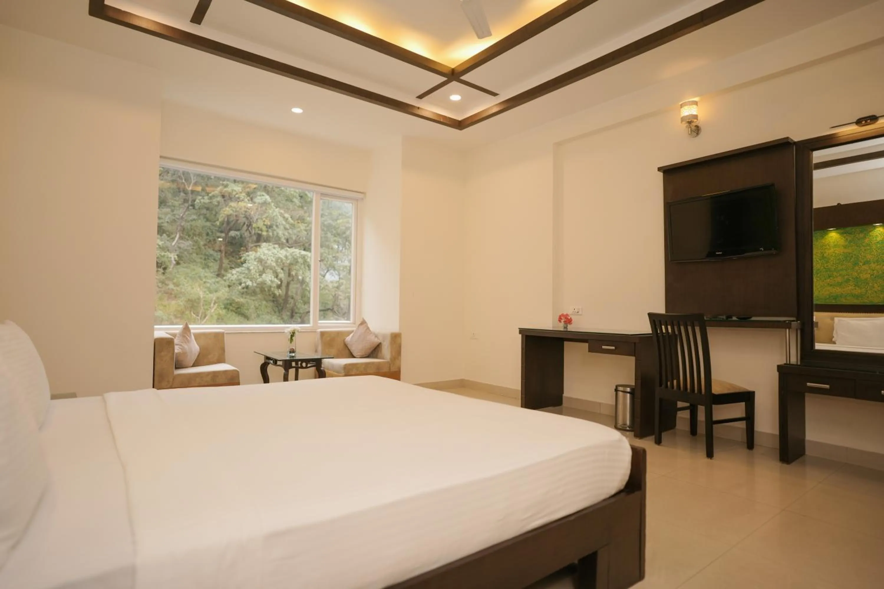 Bed in The Grand Shiva Resort and Spa