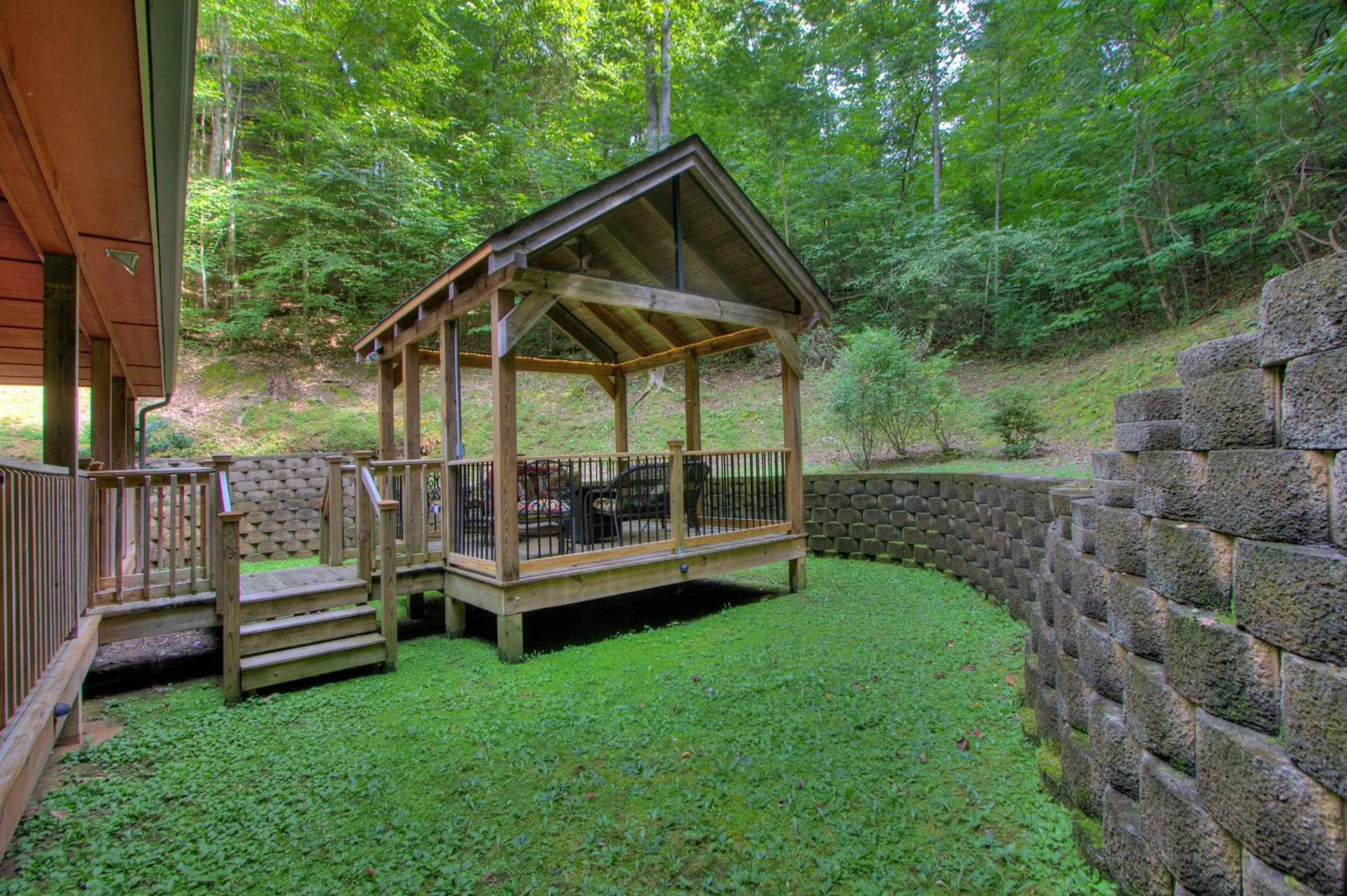 Patio in Gorgeous "Country Roads" by HoneyBearCabins 4BR 4BA, next to pool, easy drive, main strip location!