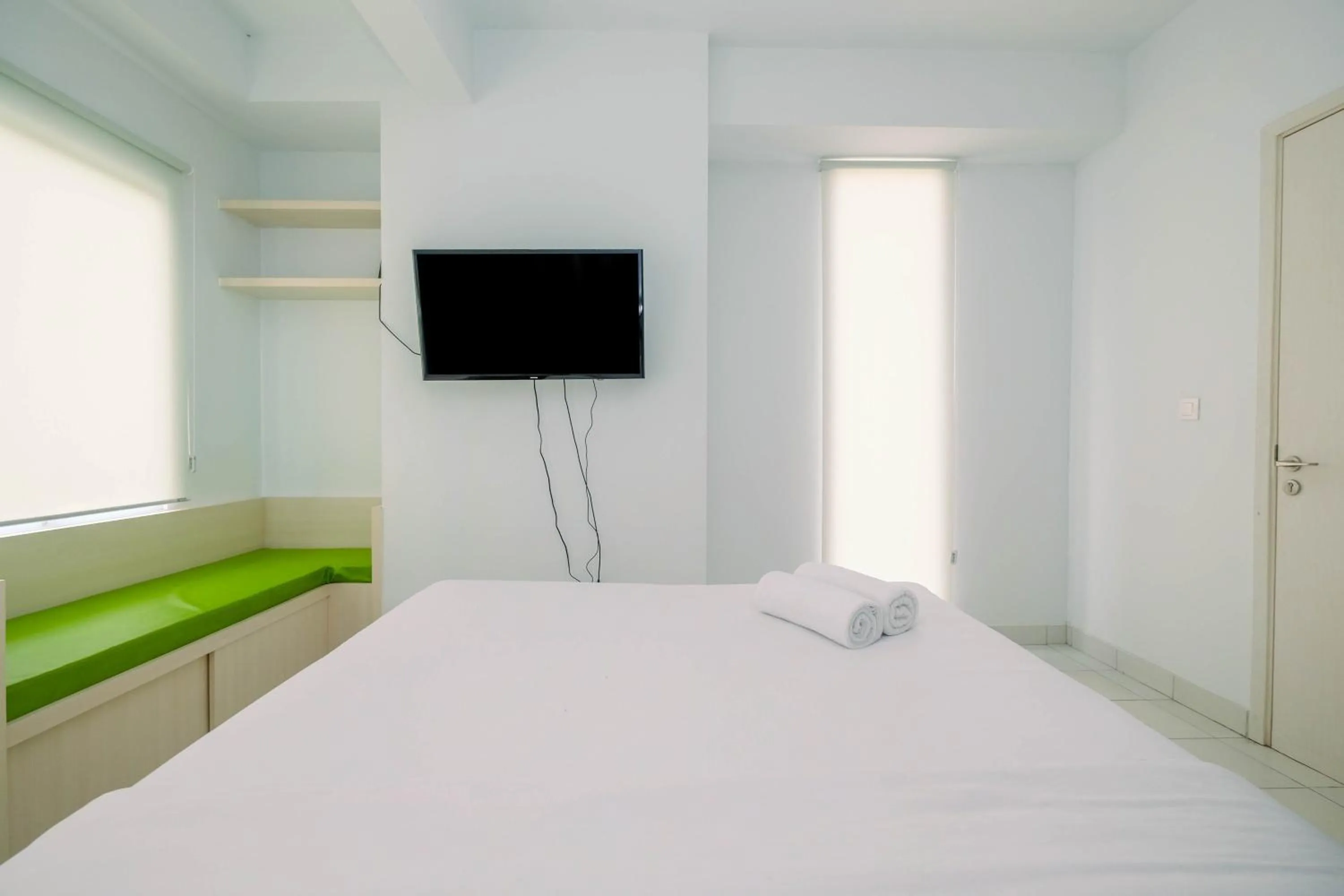 Bed in Comfy and Minimalist 1BR Patraland Urbano Apartment near Bekasi Station By Travelio