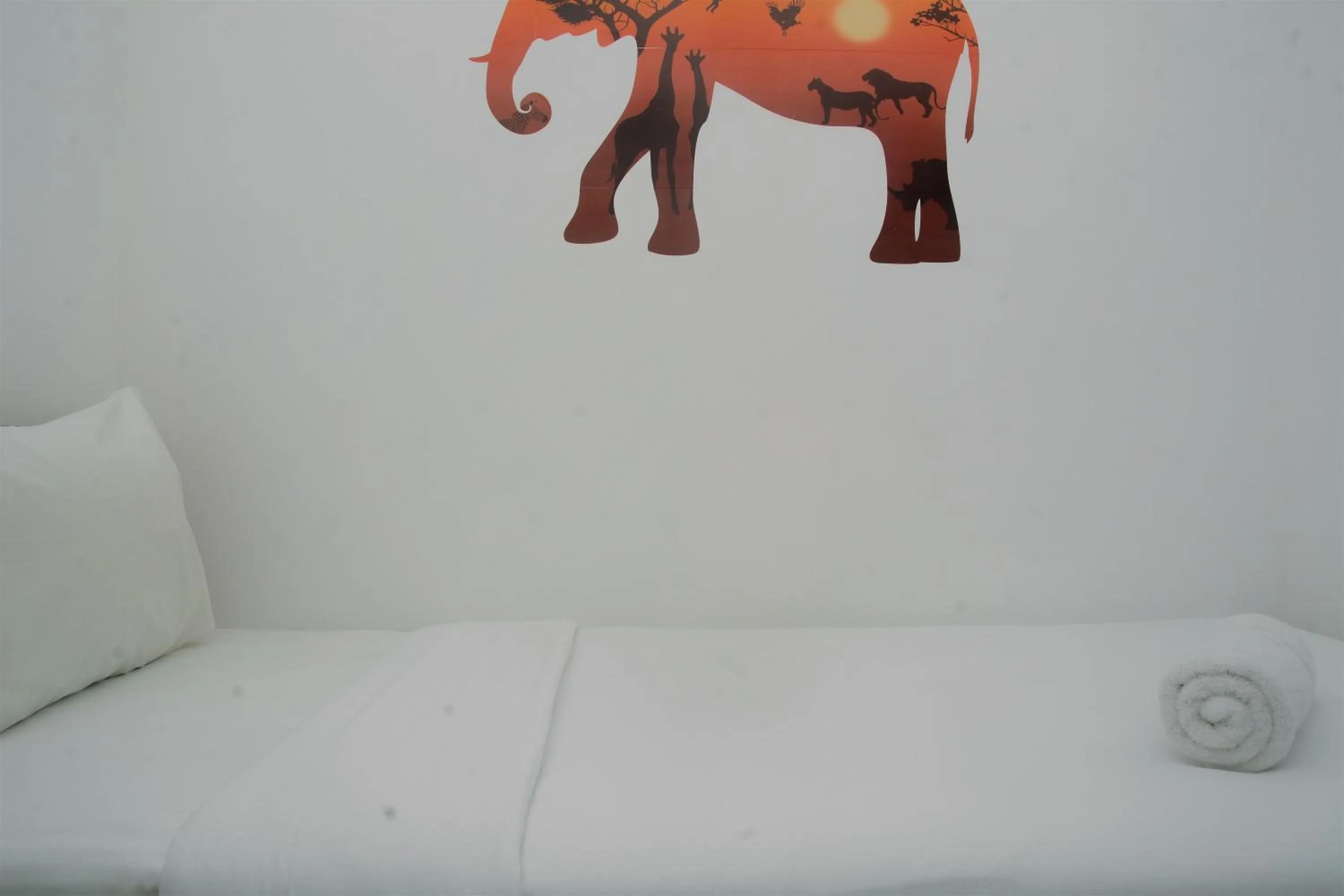 Bed in Best Deal 3BR Apartment Bassura City near Shopping Center By Travelio