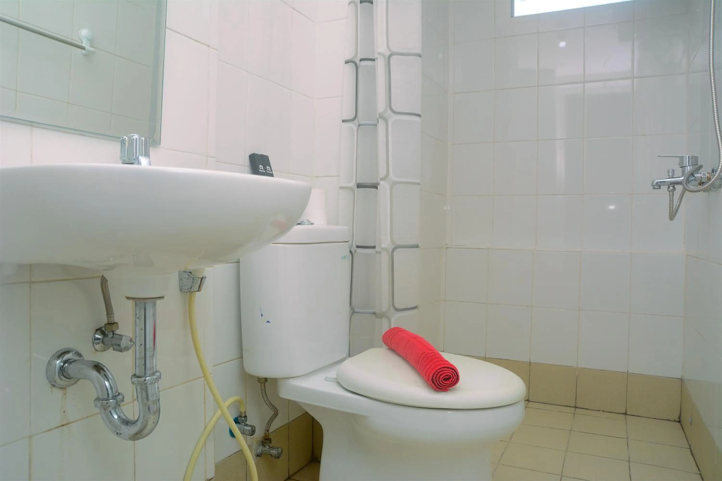 Bathroom in Best Deal 3BR Apartment Bassura City near Shopping Center By Travelio