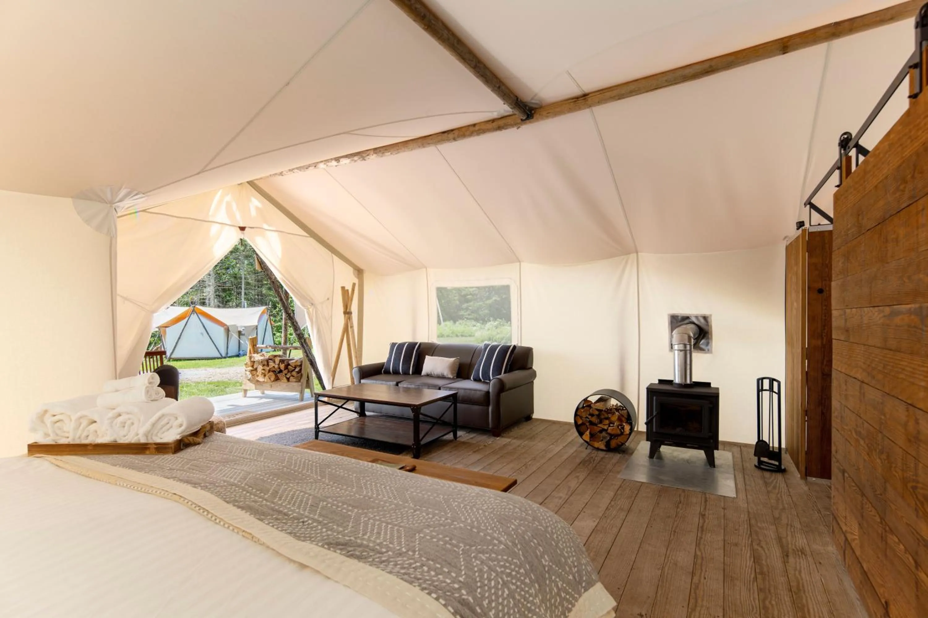 Seating area, Bed in Under Canvas Acadia