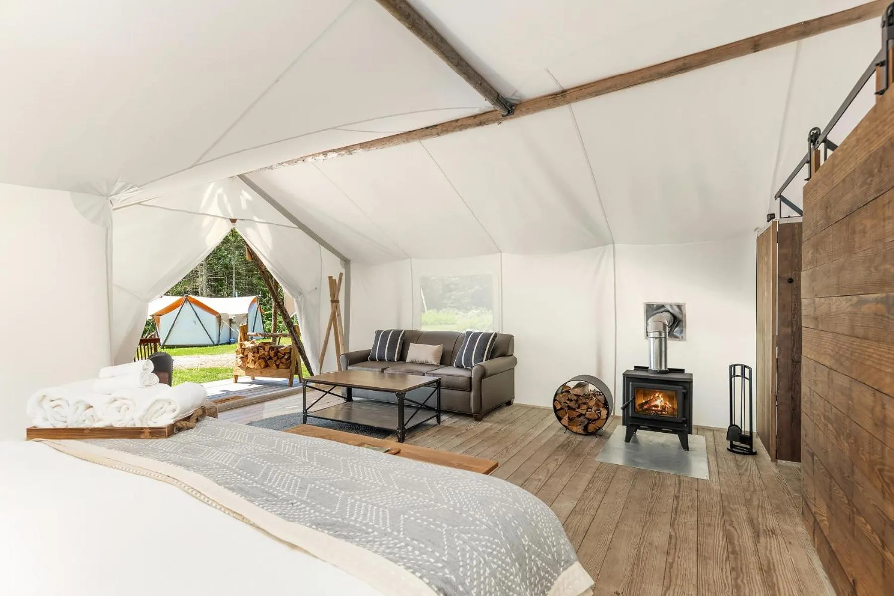 Seating area, Bed in Under Canvas Acadia