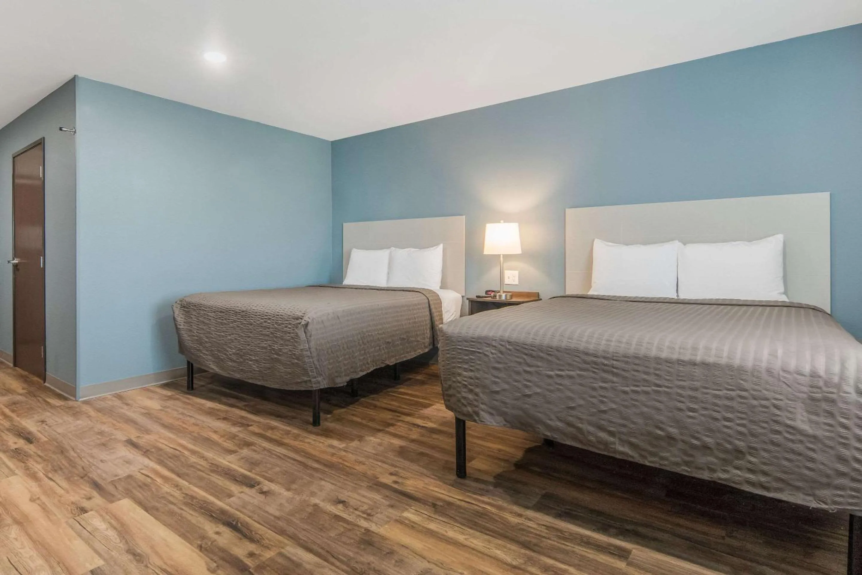 Photo of the whole room, Bed in WoodSpring Suites North Ft Worth Alliance TX Speedway