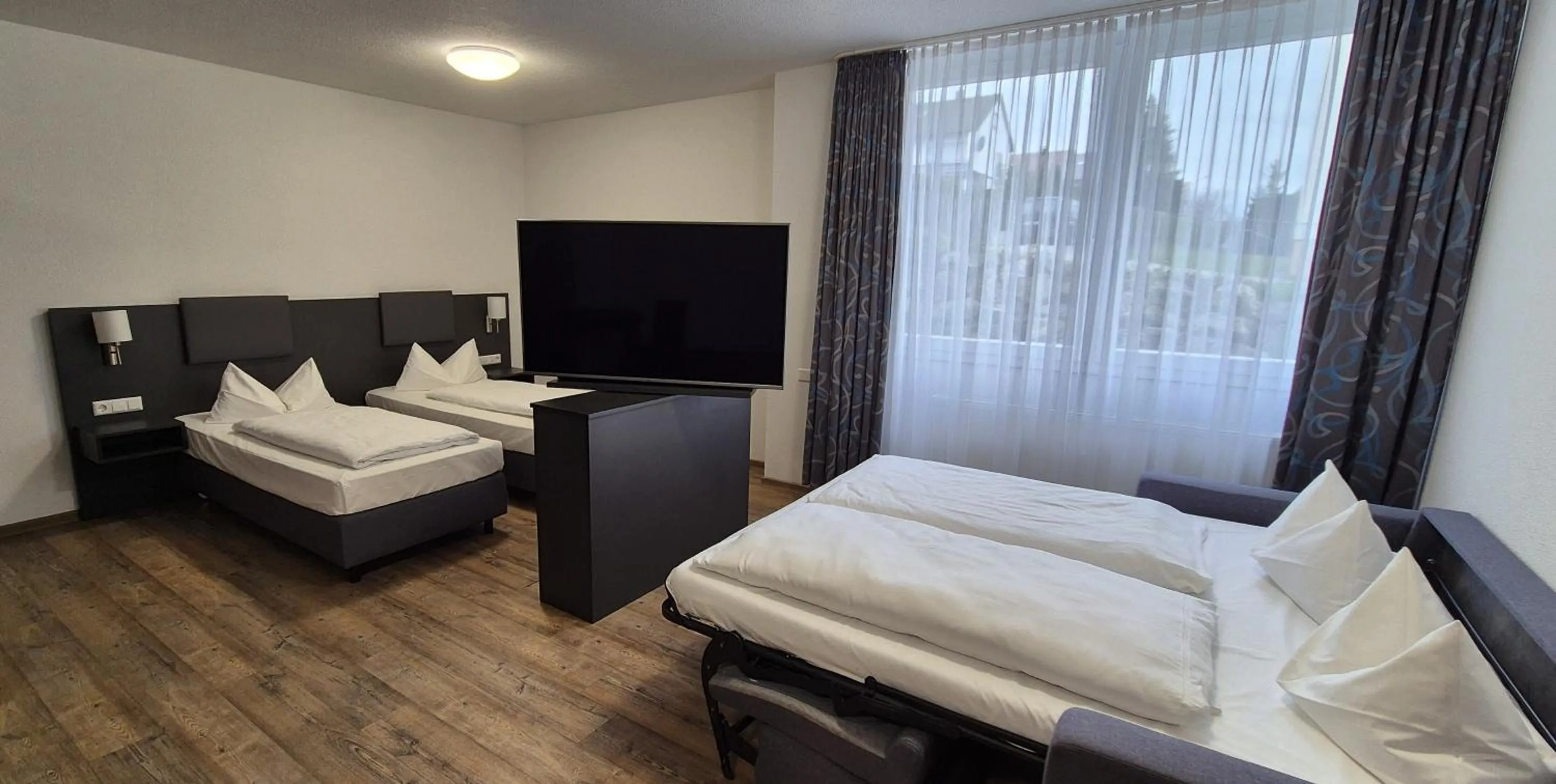 Photo of the whole room, Bed in Melvi Hotel Göppingen