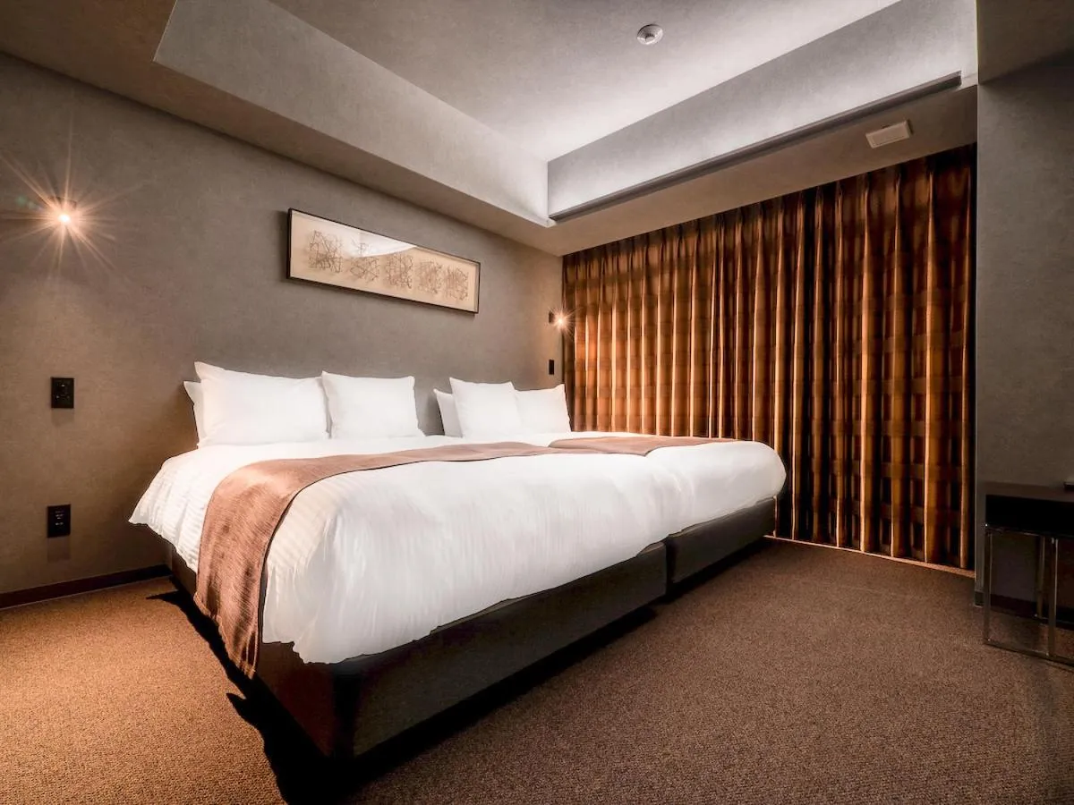 Bed in Randor Hotel Namba Osaka Suites