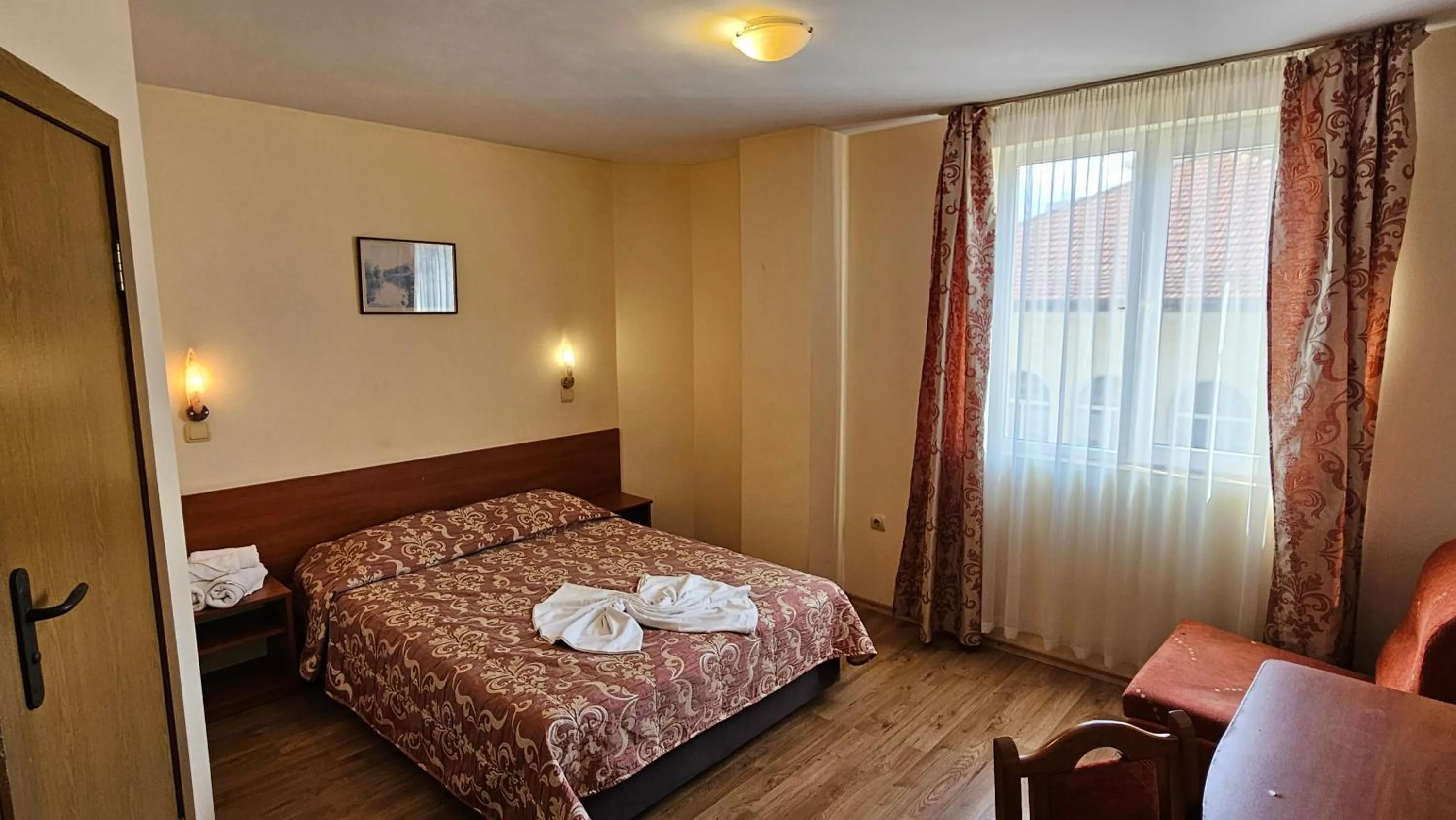 Bed in Caprice Family Hotel