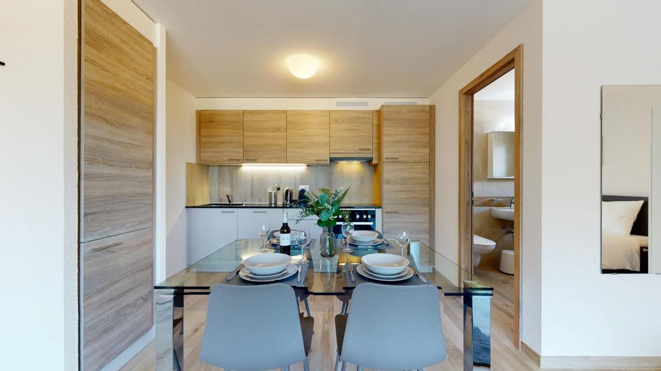 Kitchen or kitchenette in Nonanteneuf appart hōtel Aigle - contactless check-in