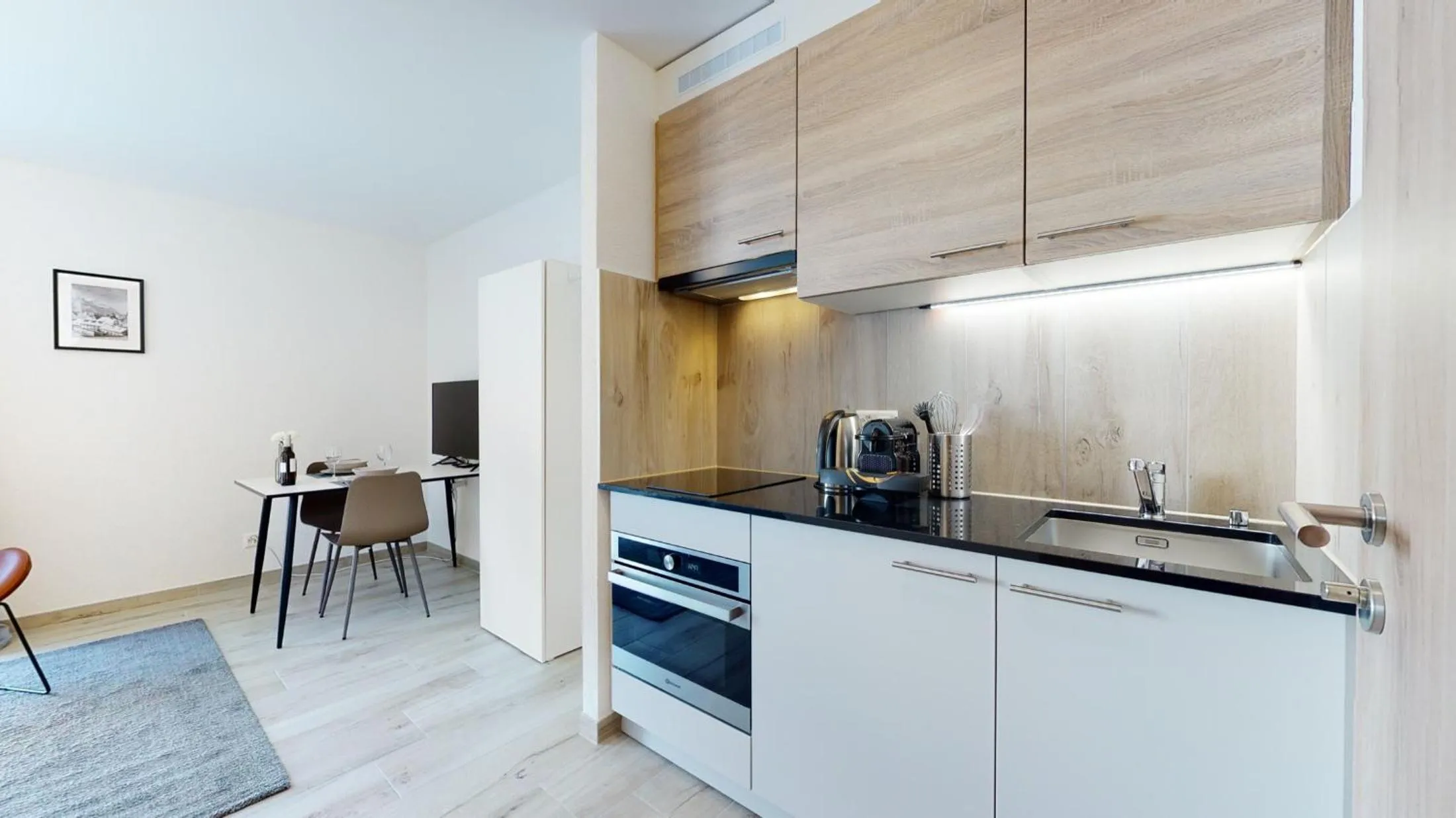 Kitchen or kitchenette in Nonanteneuf appart hōtel Aigle - contactless check-in