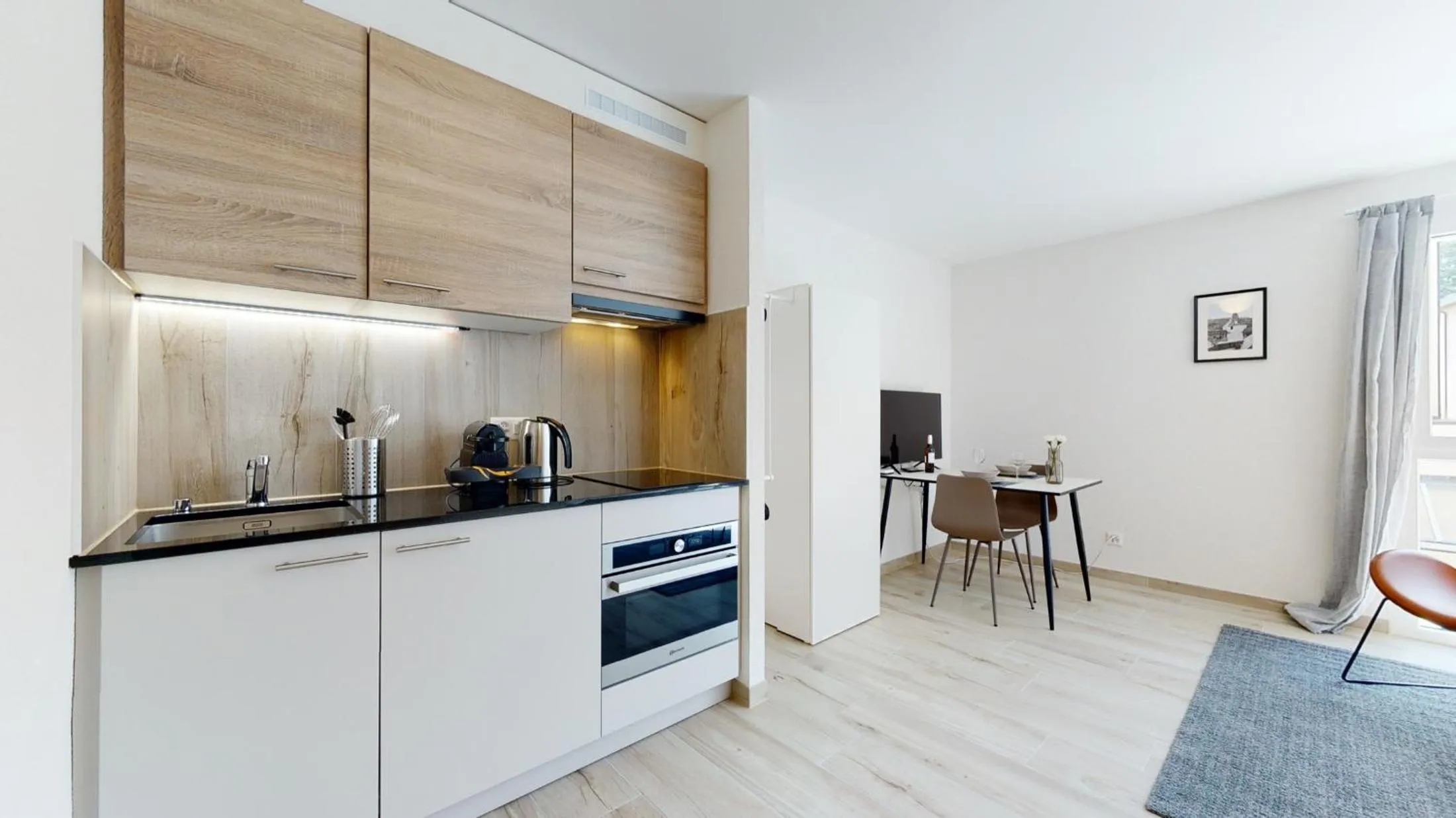 Kitchen or kitchenette in Nonanteneuf appart hōtel Aigle - contactless check-in