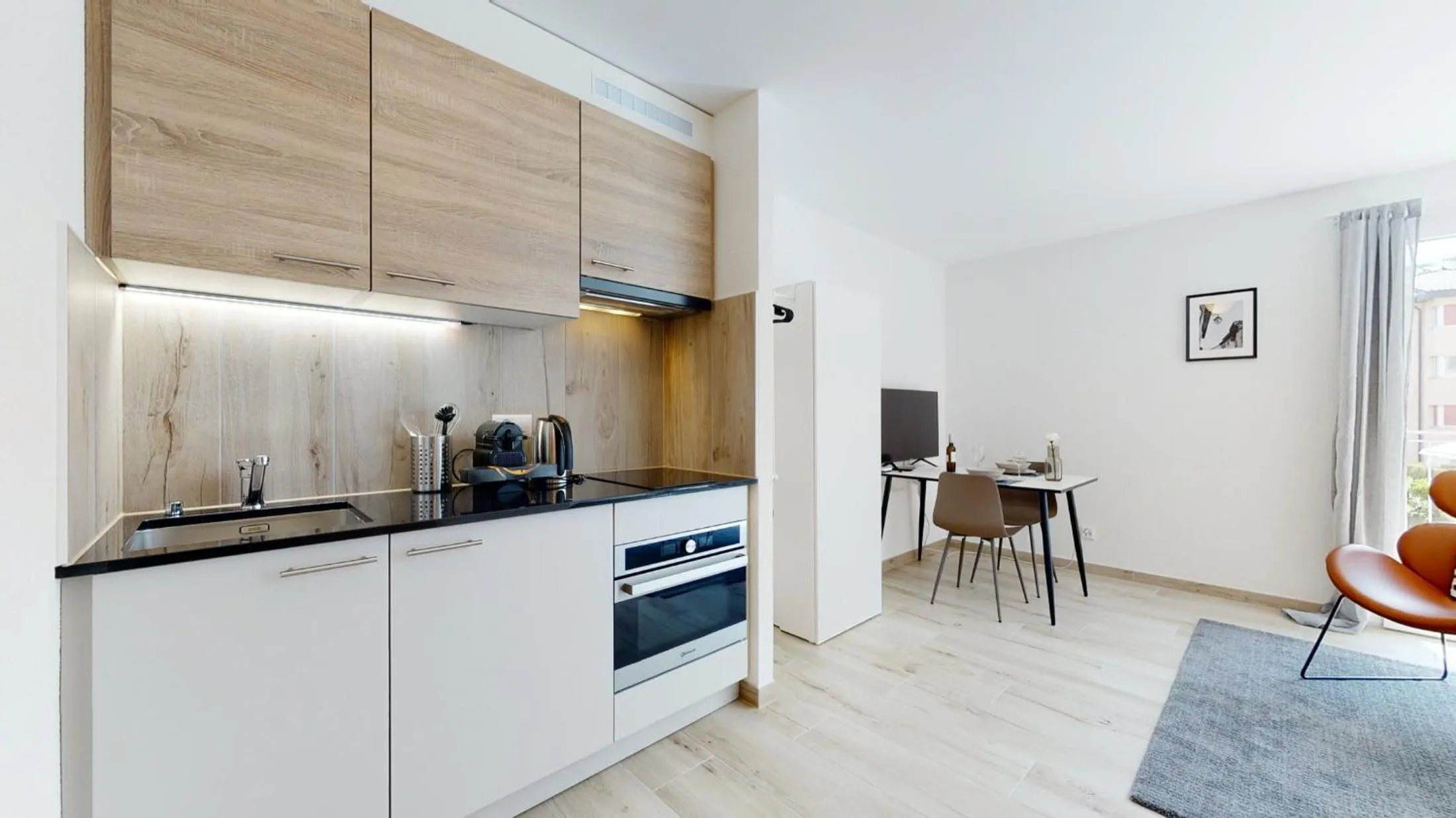 Kitchen or kitchenette in Nonanteneuf appart hōtel Aigle - contactless check-in