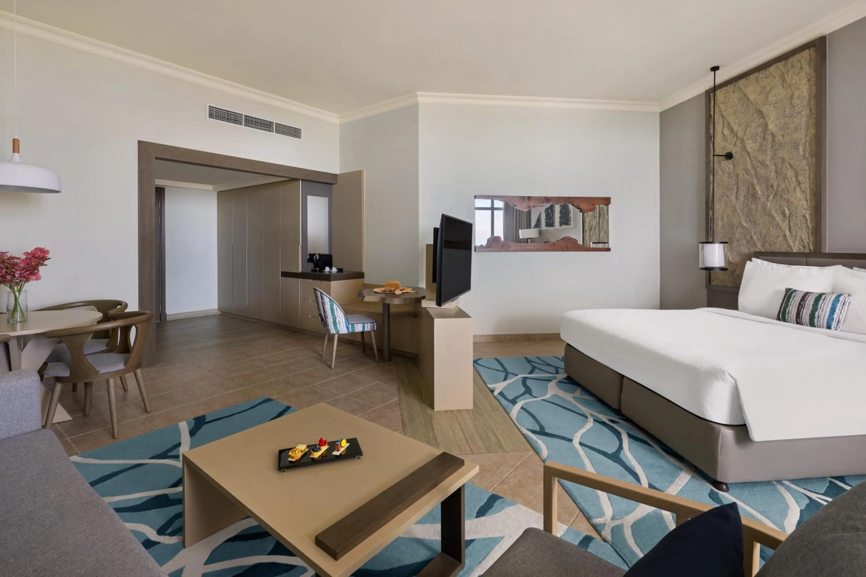 Living room, Bed in Fujairah Rotana Resort & Spa - Al Aqah Beach