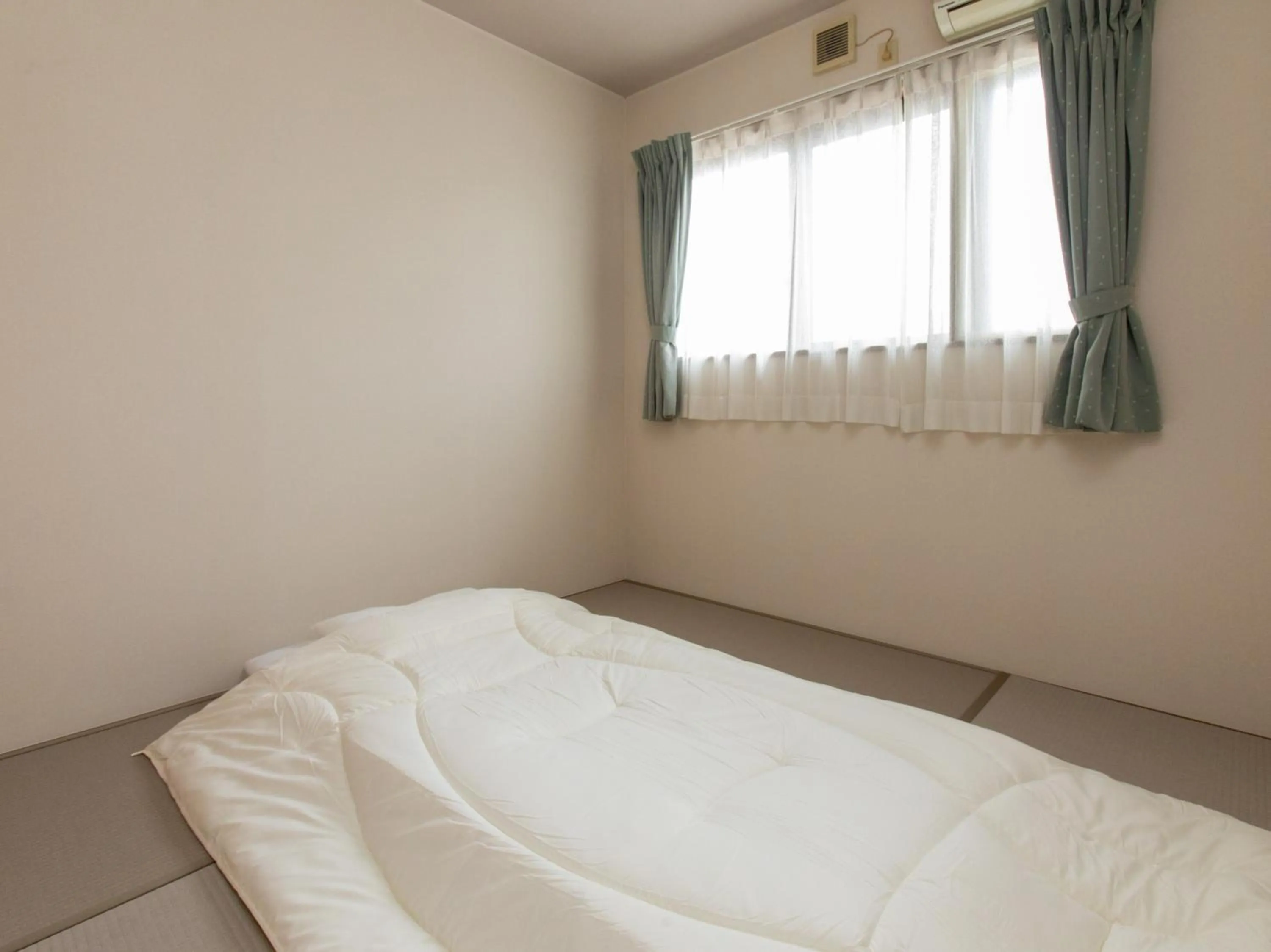 Bed in Tabist Business Ryokan Duck Ishinomaki Hebita