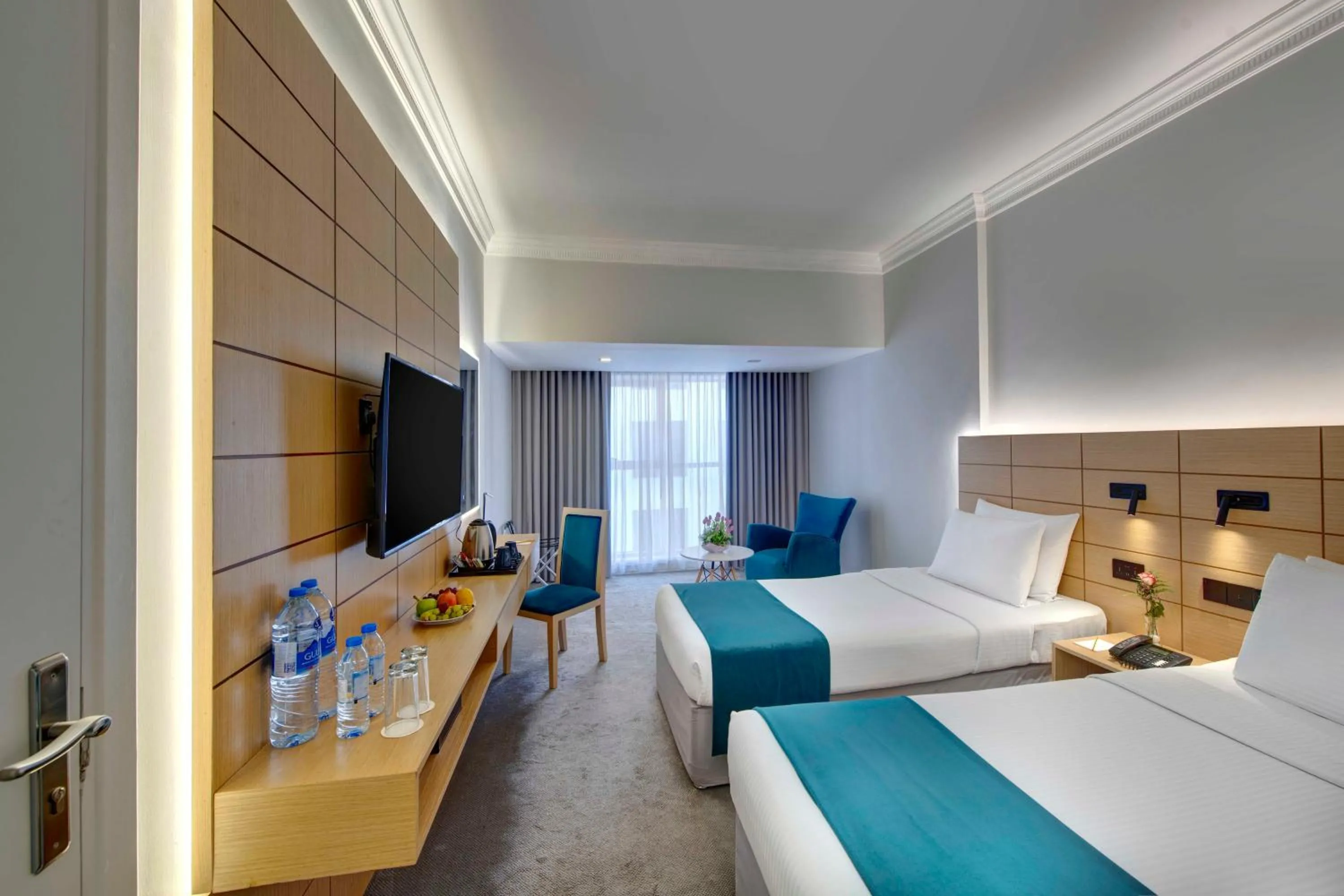 Communal lounge/ TV room, Bed in Lotus Grand Hotel