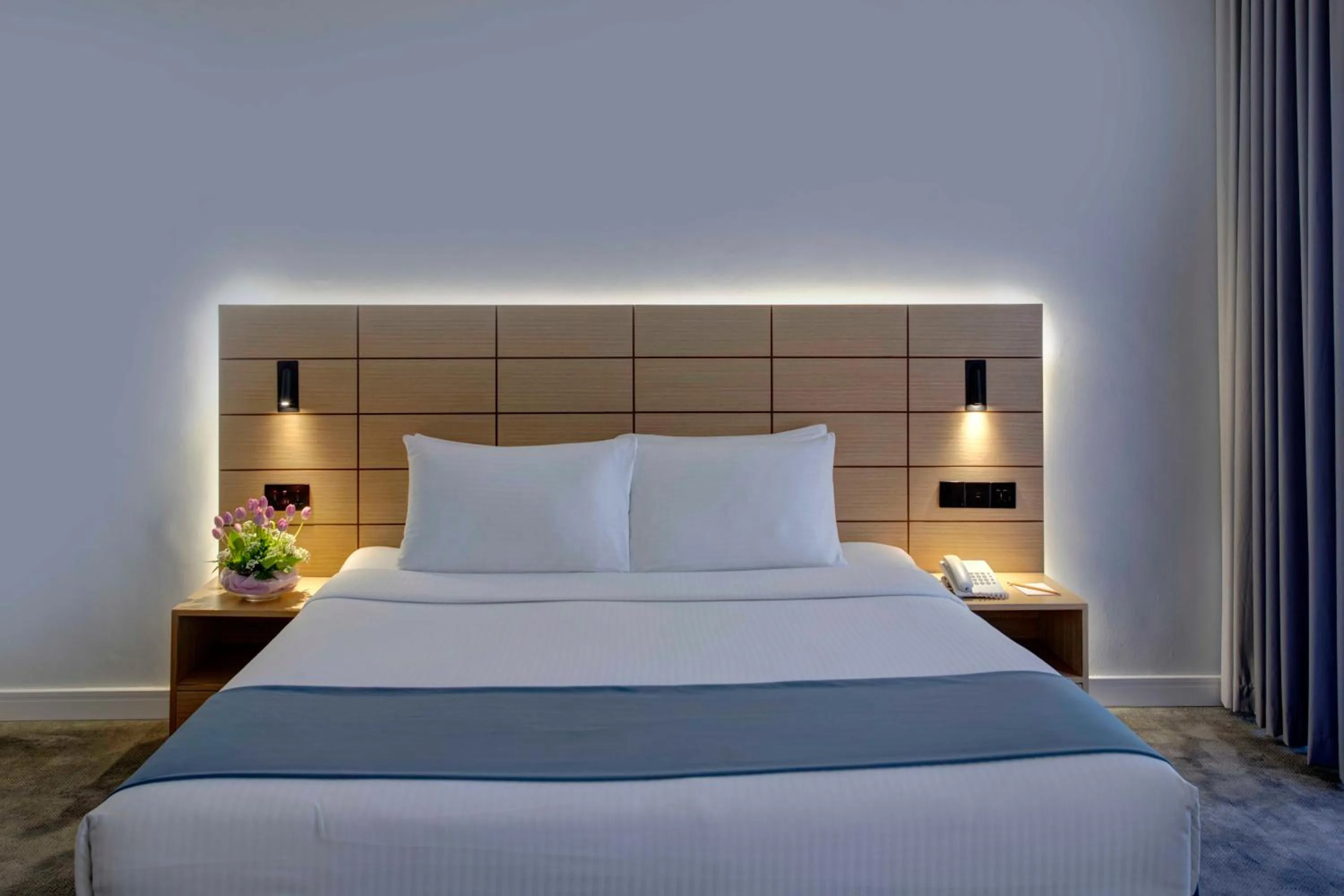 Communal lounge/ TV room, Bed in Lotus Grand Hotel