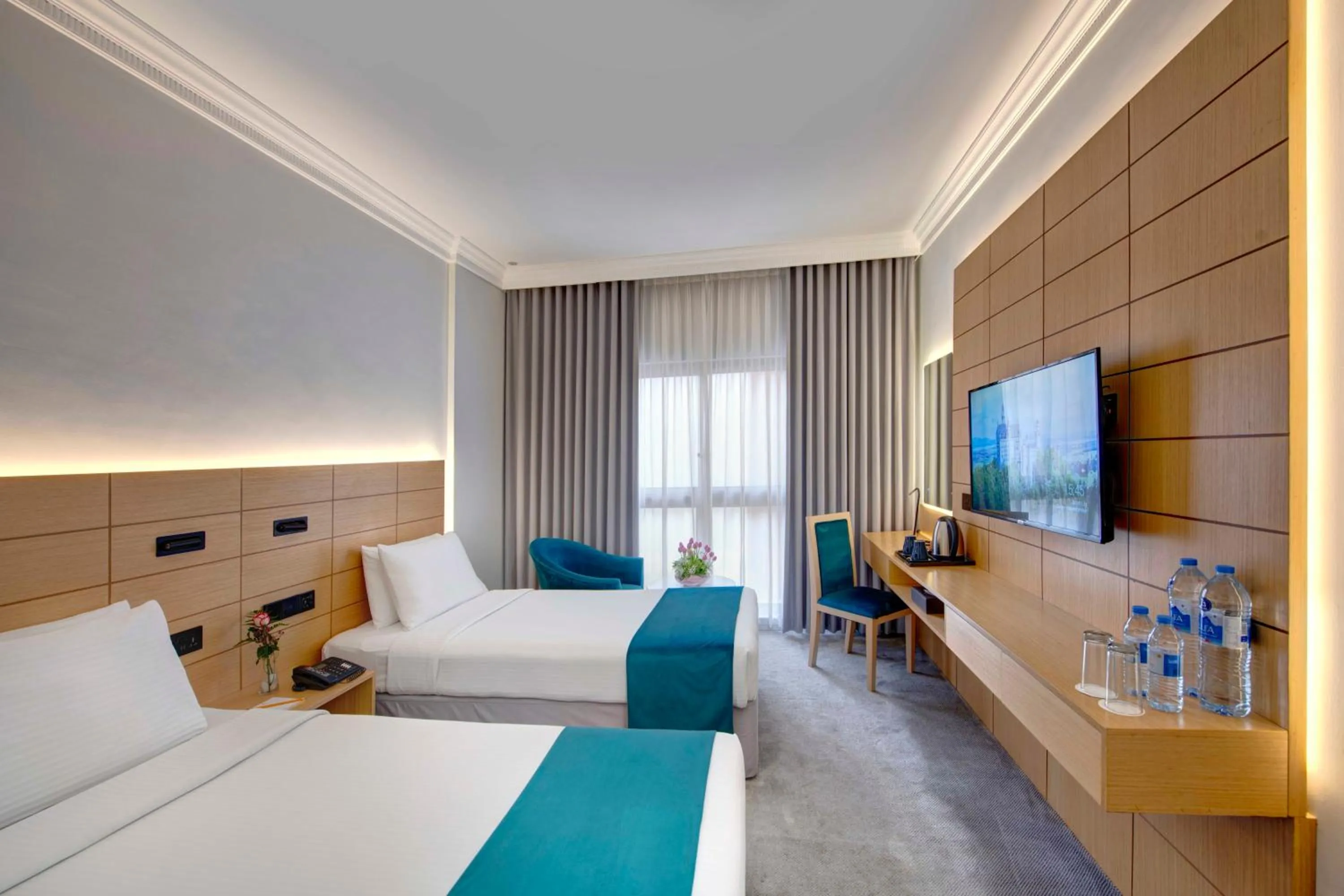 Communal lounge/ TV room, Bed in Lotus Grand Hotel