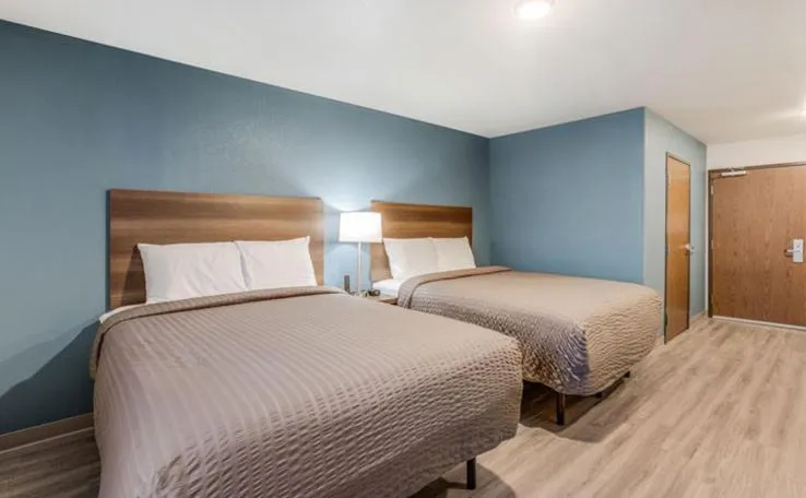 Bed in WoodSpring Suites Novi Farmington